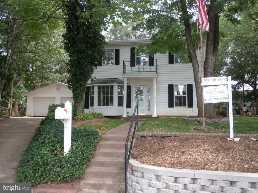 REDUCED..WONDERFUL  Colonial in Manassas Park on a cul-de-sac with 17000 sf level lot. 3 car garage with workshop.  One main level bedroom with bath. 3 bedroom upper level with 2 full bath. New carpeting upper level. Huge updated kitchen with island. 2 kitchen sinks. Wall ovens. SS refrigerator. Granite counters. Ceramic tile kitchen floor.