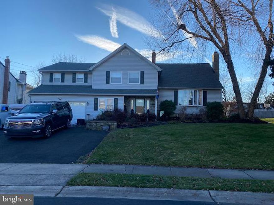 Discover an abundance of space in this 3,300 sq ft split-level home boasting 5 bedrooms, 4.5 bathrooms, and numerous upgrades. Nestled on an expansive lot (.31 Acres) within the Glenview Park subdivision in Warminster, Pennsylvania.
As you approach, the extra-wide driveway accommodates 5 cars effortlessly, leading to a generously sized two-car garage. Follow the curved sidewalk to the welcoming foyer, which provides access to a sizable home office, offering a quiet retreat from the main living areas. From the foyer, enter both the Living Room and Family Room.
The spacious living room impresses with 11’ ceilings, a large bay window, laminate flooring, and a striking floor-to-ceiling wood-burning stone fireplace. Adjacent is the expansive, updated eat-in kitchen (renovated in 2021), featuring stainless steel appliances, a custom island, a coffee bar, and optional built-in beer taps. A sliding door opens to the covered deck with custom finishes, extending from the kitchen, and an optional outdoor TV.
Descending a few steps (accessible from the foyer) leads to a half bath and a large family room with another floor-to-ceiling wood-burning stone fireplace, a custom bar, and an entertainment center. Custom low-voltage lighting highlights the wall art, and sliding doors provide access to the rear yard.
From the Living Room, ascend to the upper levels where four bedrooms await, including Bedroom #1, a primary suite with a huge walk-in closet, cathedral ceilings, a full bath, and a skylight over an oversized Jacuzzi tub and large walk-in shower. Bedroom #2 features a substantial walk-in closet, while Bedroom #3 is versatile, suitable for a nursery, young child, or a second home office.
A common full bath is conveniently located off the oversized hallway. Ascending a few steps leads to the top level, housing Bedroom #4 with an oversized closet and a private full bath.
Off the Family Room, discover a bonus space with cathedral ceilings, skylights, a large storage closet, and access to the oversized 2-car garage. Adjacent is the private 5th bedroom area, not technically an in-law suite but offering a large seating area with cathedral ceilings, skylights, a wet bar, a spacious bedroom, and a full bath.
The oversized garage features custom cabinetry for ample storage and a utility sink. Off the foyer, find a small basement laundry room and utility room. The High-Efficiency Washer and two Gas Dryers are optional with the property.
The fenced-in rear yard boasts a 20x40 concrete swimming pool with paver walkways, secured by a separate fence. A generous 12x24 detached shed with a garage door provides ample storage for yard equipment, and a small raised garden area completes the package. Access the attic via pull-down stairs for additional storage space. This is an "AS-IS" sale.