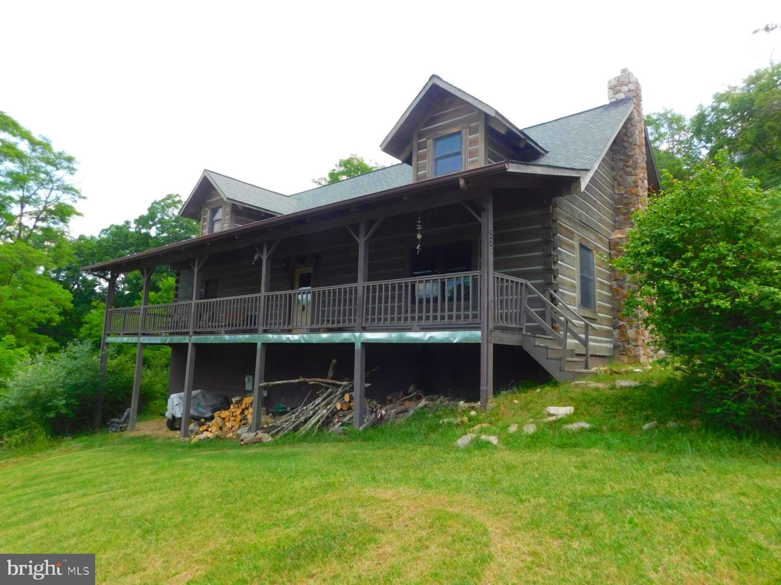 Spacious 3 bedroom 3.5 bath log cabin in a beautiful setting. Enter the cabin to combination Great Room/Dining/Kitchen area. Wood floors and huge wood burning fireplace. Spacious area that makes entertaining easy. Primary bedroom and primary bathroom are on the main level. There is also a half bath and mudroom/laundry room. Ascend the stairs to the second level where you will find a large loft/family room, two more bedrooms and a shared full bathroom. The lower level basement has 9 foot ceilings a fully finished bathroom and a huge space to do whatever you may want to do! Sit on the front porch and watch the mountain views or hike down the side of the house where there is a great spot for a fire pit. Upper cove lake is only 3/4 of a mile away.