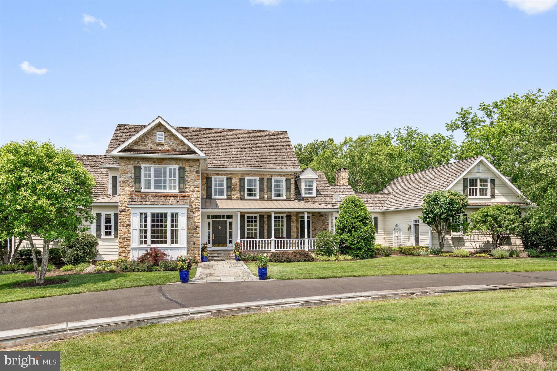 Set well off the road in the coveted Jericho Valley of Upper Makefield Township, Winding Creek Manor is a one-of-a-kind estate backing to the serene Pidcock Creek. This extraordinary property, the final custom home by renowned builder Ferman Lex, offers privacy, elegance and unmatched recreational amenities in one of Bucks County’s most prestigious settings. The main residence features 5 bedrooms and 7.2 baths, finished across four beautifully appointed levels. A privately situated first floor primary suite and nearby office create an ideal layout for multi-generational living, allowing for a one-level lifestyle. The spacious bedroom is enhanced with a full bath with a radiant heated floor, dressing closet, and make-up vanity area. At the heart of the home, a dramatic two-story great room opens to a formal dining room, and a spacious open kitchen and family room with fireplace, anchored by a convenient side entrance/butler’s pantry- perfect for both intimate gatherings and large-scale entertaining. Throughout the home, custom millwork, rich hardwood floors and premium finishes reflect a commitment to quality and craftsmanship. The two upper levels offer additional bedrooms and baths, all en-suite, a generous landing, ideal for a reading nook, and ample closet space with wood shelving. The fully finished lower level is designed for fun, featuring a home theater with tiered seating, a full-service bar, grand game and gathering spaces, and a full bath. A tucked away gym with mirrored and glass walls overlooks the indoor heated saltwater game pool and spa, forming a resort-style centerpiece for year-round enjoyment. Surrounded by French door sliders, a flagstone surround, full bath/changing cabana, and kitchenette, this private oasis is enhanced by an auto-safety cover for peace of mind. Outdoor living is equally impressive, with a newer attached screened porch (2016) with vaulted beamed ceiling, a stone wood-burning fireplace and retractable screens for 3-season use. A second detached screened pavilion is finished with an outdoor kitchen with built-in gas grill, and there is a firepit for relaxed evening gatherings. The attached oversized 3-car garage includes a finished upper level with abundant natural light, a kitchenette and full bath- ideal for a home office , studio, or additional guest accommodations. And for the athletic enthusiast, a newer carriage/garage, built by Tim Sager in 2012, includes a full-size indoor squash/sports court, and two extra tall and oversized garage bays. A finished second floor including 3 rooms, finished with hardwood flooring, built-in cabinetry, and a full bath, is set for a variety of uses. The grounds are private and rolling, with long-distance views of the Jericho Mountains, and the Pidcock Creek gracing the rear of the property. Some additional features include zoned HVAC, a Generator, central security, central vac, and a Sonos music system. Located in the Council Rock School District, and offering easy access to I-95, Princeton, airports and shore destinations, this inviting property represents a rare opportunity in one of Bucks County’s finest locations!