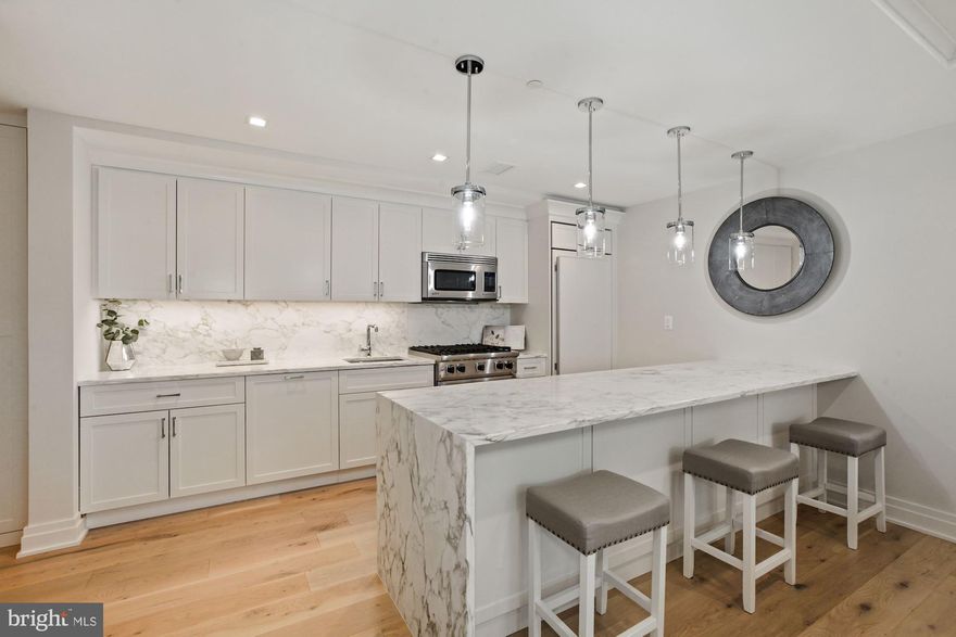 A FABULOUS price for a luxury condo! Welcome to The Lauren, downtown Bethesda s premier luxury condominium building, offering the best in elevated urban living. Enjoy ultimate convenience in an incredible location with white glove service in this luxurious full-amenity building. This spacious condo offers 1,248 square feet of well-appointed living spaces, two bedrooms and two bathrooms. The residence is basked in sunlight with private tree-top views, window-lined walls and two balconies. High design features include large-plank white oak hardwood flooring and tray ceilings. The stunning kitchen boasts marble waterfall countertops, a large island with seating, and high-end Viking, Subzero and Bosch appliances. The Master suite features multiple closets with custom built-in drawers and a lavish bathroom with large rain shower and bench. The second bedroom has a private balcony and large walk-in closet. This condo offers a washer and dryer within the unit and conveys two parking spaces and a separate storage space. The Lauren is a boutique building with only 34 units and offers five-star amenities including a 24-hour concierge, state-of-the-art fitness facility, limited-access elevators and valet parking. Residents have superior entertaining options with the private Onyx Lounge and wine bar and an expansive rooftop deck, both areas equipped with a catering kitchen. The building has taken impressive steps to safely accommodate its residents during this time. New to the market and never occupied, this incredible unit is the luxury condo you have been waiting for! Video Tour: https://vimeo.com/490350133