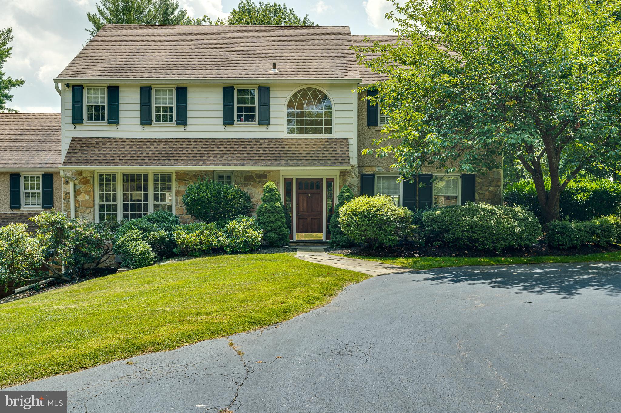 Rare opportunity to own a beautiful home that overlooks the 17th hole of the prestigious Merion East Golf Club. Enjoy this 3 bedroom house on a private 1.69 acre lot with inground salt water pool, spa and gazebo and a large 2-car attached garage.
The circular driveway brings you to the front door surrounded by lush terraced landscaping and magnificent trees. The 2 story center hallway leads you into the living room with fireplace, a staircase to the 2nd floor, a 1/2 bath, stairway to basement and eat in kitchen. There is a fully equipped first floor laundry room and family room/office with fireplace full bath and wet bar. The light filled dining room can be entered from the kitchen and living room and overlooks the beautiful deck and grounds. The upstairs has a large master suite with master bath and walk in closets and walk up attic. There are 2 additional bedrooms and full bathroom completing the upstairs space. The basement has a full walk out which leads to the garage. The property was renovated in 2014. Included in the renovations were: new roof, attic insultation, exterior stucco and cedar siding, paint-inside and out, refinished hard wood floors, new kitchen appliances, washer & dryer, new high efficiency heater installed in the unfinished full basement, air conditioning with 3 zone secondary programmable thermostat, secondary air for upstairs, estate fencing, new back patio doors and automated irrigation system. pool & spa entirely renovated with all new equipment, new plaster & tile. New back patio doors in 2018. Recent renovations (2019) include deck refinishing . This property is within walking distance to Haverford College, shopping, transportation, hospitals and restaurants. Don't miss this rare opportunity for convenience and luxury.