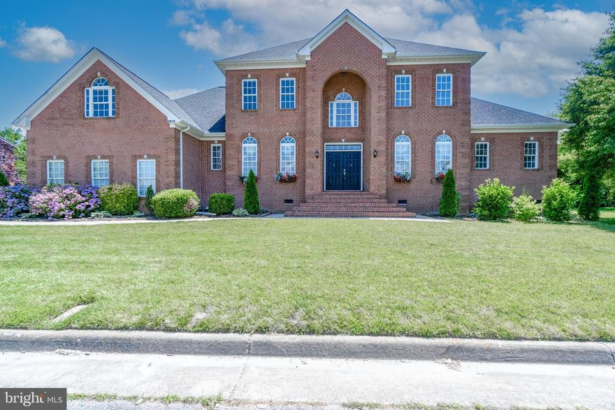 Stunning! This luxurious all brick custom-built masterpiece, with over 4500 sq ft of living space, 5 BR, 3.5 bath home is entertainer's paradise and haven for families.  Enter the open 2-story foyer with 1st floor Master BR with dual shower and jacuzzi bath tub, all BRs with walk-in closet, a 4-stop elevator effortlessly gliding you between floors, large rec room above garage, 3-zone HVAC system, two gas water heaters with endless hot water, new roof with 50-year warranty, expansive kitchen with stainless steel appliances, walk-in pantry, trash compactor and stunning granite countertops, 3 gas fireplaces, walk-up stairs to attic providing additional storage or future expansion, 3-car garage, high ceilings on 1st and 2nd floors, 2 outdoor porches, large 0.4-acre lot, in-ground sprinklers with a well, lawn light posts in backyard create a magical ambiance, nestled on a cul-de-sac in waterfront neighborhood with boat slip availability, from its prime location to its impeccable design, this home is sure to impress your friends and family, leaving a lasting impression.