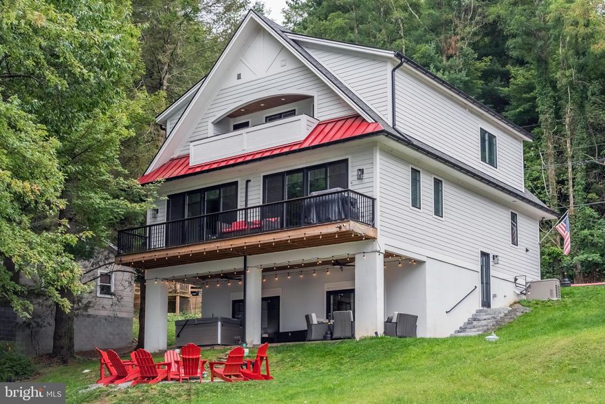 Stunning contemporary lakefront home! This home leaves nothing to the imagination, offering an open floorplan, kitchen island, six burner propane range, two refrigerators and luxury vinyl tile flooring. The main level propane fireplace is very modern and makes the living room feel warm and inviting. The six bedrooms (four of which are en-suites), three levels of living space, an upper level sitting area, and a lower level family room provides plenty of space to enjoy with family and friends. No stone was left unturned with this design, and almost every room offers breathtaking water views. The 60' of lakefront, type A dock, multiple decks, balcony, firepit and hot tub makes the outdoor space just as enjoyable. The location is also less than a mile to Wisp Ski Resort, and just a few miles to Lodestone Golf Course. Truly a four-season master piece.