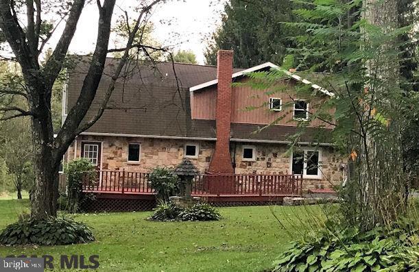 Pull in the drive and fall in love with this charming stone cottage in a partially wooded setting! From the beautiful grounds to the comfy living space, this home offers you first floor living options with plenty of room for family and company too! The first floor is remarkably open with a good-sized living room plus a huge family room that could also be a 1st floor Master. The upstairs Master has an adjoining room for 2nd floor family room or an extra bedroom. Lots of closet space too! Spend your summers lounging on the deck or hosting picnics rain or shine in your private backyard pavilion. In spring and fall, you can putter away in your potting shed then bring your projects inside for the winter with the oversized laundry/mudroom providing lots of hobby workspace. With a 2-car garage and 1.4 wooded acres, this property packs a punch for the price! Visit Virtual Tour at https://rem.ax/2wIc2VT