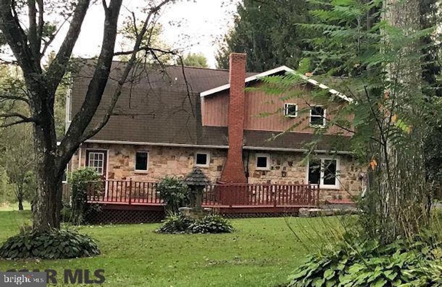 Pull in the drive and fall in love with this charming stone cottage in a partially wooded setting!  From the beautiful grounds to the comfy living space, this home offers you first floor living options with plenty of room for family and company too! The first floor is remarkably open with a good-sized living room plus a huge family room that could also be a 1st floor Master. The upstairs Master has an adjoining room for 2nd floor family room or an extra bedroom.  Lots of closet space too! Spend your summers lounging on the deck or hosting picnics rain or shine in your private backyard pavilion.  In spring and fall, you can putter away in your potting shed then bring your projects inside for the winter with the oversized laundry/mudroom providing lots of hobby workspace. With a 2-car garage and 1.4 wooded acres, this property packs a punch for the price! Visit Virtual Tour at https://rem.ax/2wIc2VT
