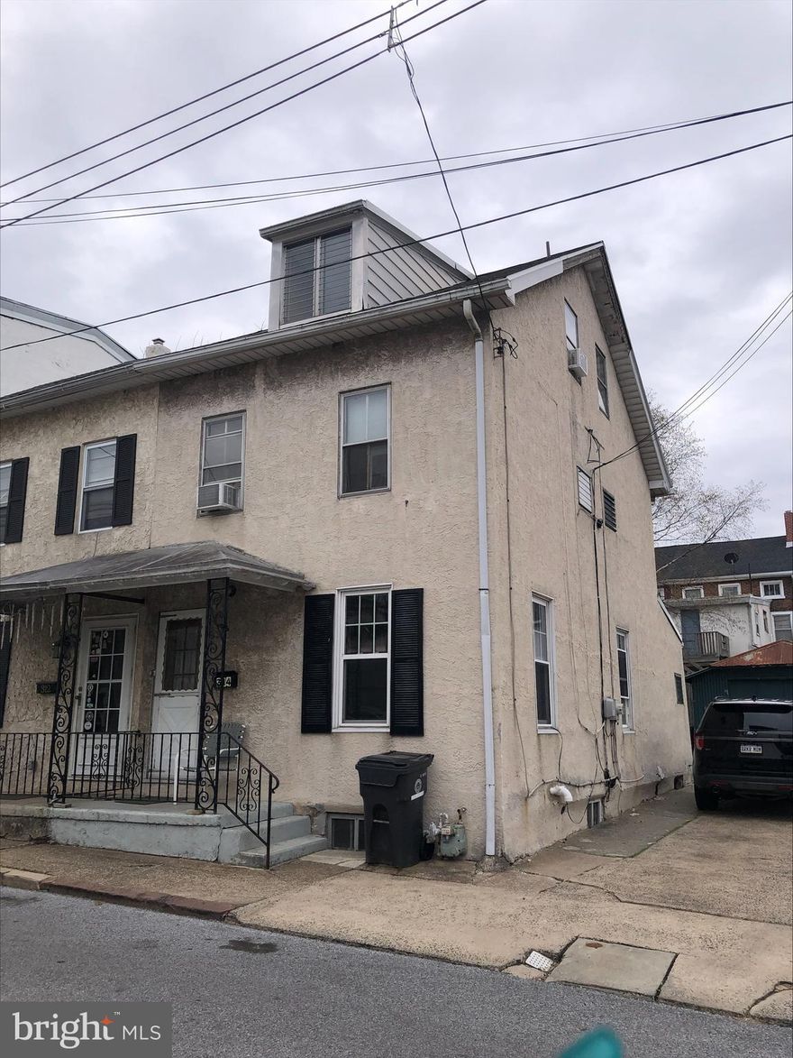 Contractors Dream! This large End unit has Its own private driveway, yard, lots of space- Needs everything except the big stuff. Roof newer, heater, water heater and lots of newer windows.  Everything else needs work!! Being sold 100% as is.