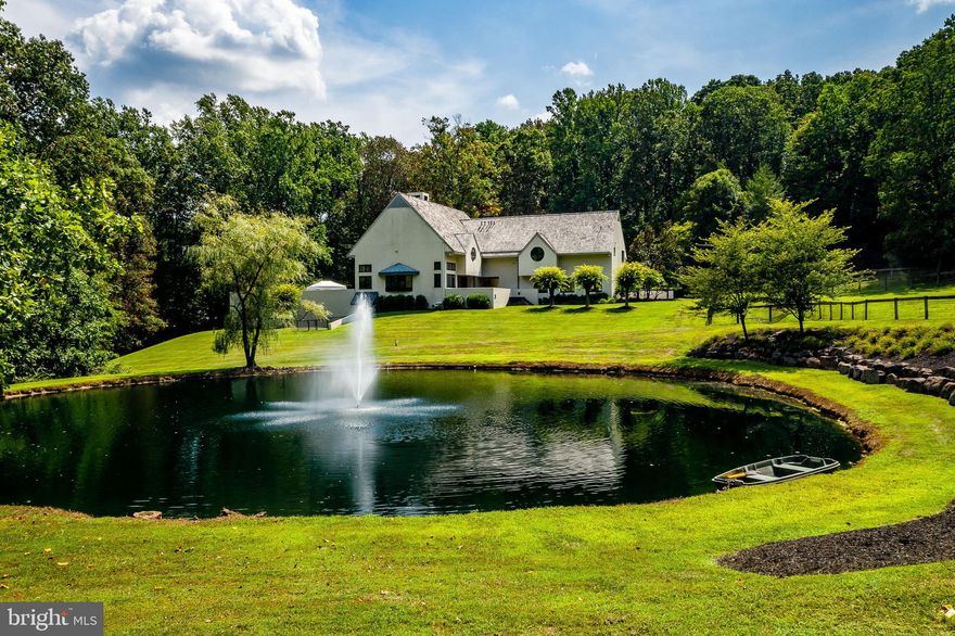 Set well off the road on 8.6 exceedingly private acres, sits this phenomenally dramatic 6200 +/- square foot home with high ceilings, generous use of exotic woods, and fabulous architectural details. The home was built by a builder for his personal use so the quality of the home is spectacular. Your guests will be dazzled by the Great Room with its 18’ ceiling, loads of glass offering pastoral views of the pond, its access to the grand pebble pool, the adjoining cozy conversation area with a fireplace, and the stunning bar. The Kitchen and Breakfast Area are like an architectural work of art! The Kitchen boasts 12’ ceilings, custom-crafted cabinetry, stainless appliances, and Carrera marble counters and backsplash. The Primary Suite could easily grace the pages of a designer magazine featuring an 18’ ceiling, fireplace, walls of custom built-in cabinets, a staircase to the Office, loads of closet space plus a walk-in. The Primary Bath displays walls of marble, a stunning marble floor, wood ceiling, soaking tub, and more. Upstairs, the private Office overlooks the Great Room and you will love the fireplace during those cozy winter days. On this level is also found a large Upper-Level Family Room that overlooks the Great Room and is equipped with loads of built-ins plus a wine cooler and ice maker. Also, found on this level is a large apartment that can be accessed from here or from exterior access. The Apartment has a large Living Room, eat-in Kitchen, Powder Room, Laundry, Changing Room with a wall of fabulous built-ins, and a large Bedroom. The main house Lower Level has a wonderful Sitting Area that could be a play area and a perfect spot for the pool table. A Bonus room and Bath/Laundry are also on this level in addition to loads of storage. The home’s geothermal heating and cooling system are also found here. The pond features a fountain and is well stocked with large-mouth bass, sunnies, and catfish. The home also has a three Car Garage that is easily accessed through a breezeway with lots of closets and storage space. Living here is like residing in your own resort! The equestrians in the family will love the six-stall Barn - all with exterior access, heated waterers, and state-of-the-art fly control! Additionally, the Barn has a large heated Tack Room, Wash Stall with hot water, Feed Room, Tractor Shed, and a large loft with direct access for hay drop to each stall. Of special note is that several trails are easily accessed from this property with direct access to Woody's Woods. This property is also convenient to commuting routes, minutes drive from picturesque Saint Peters Village, the renowned La Maison Restaurant, and in the sought-after Owen J. Roberts School District!