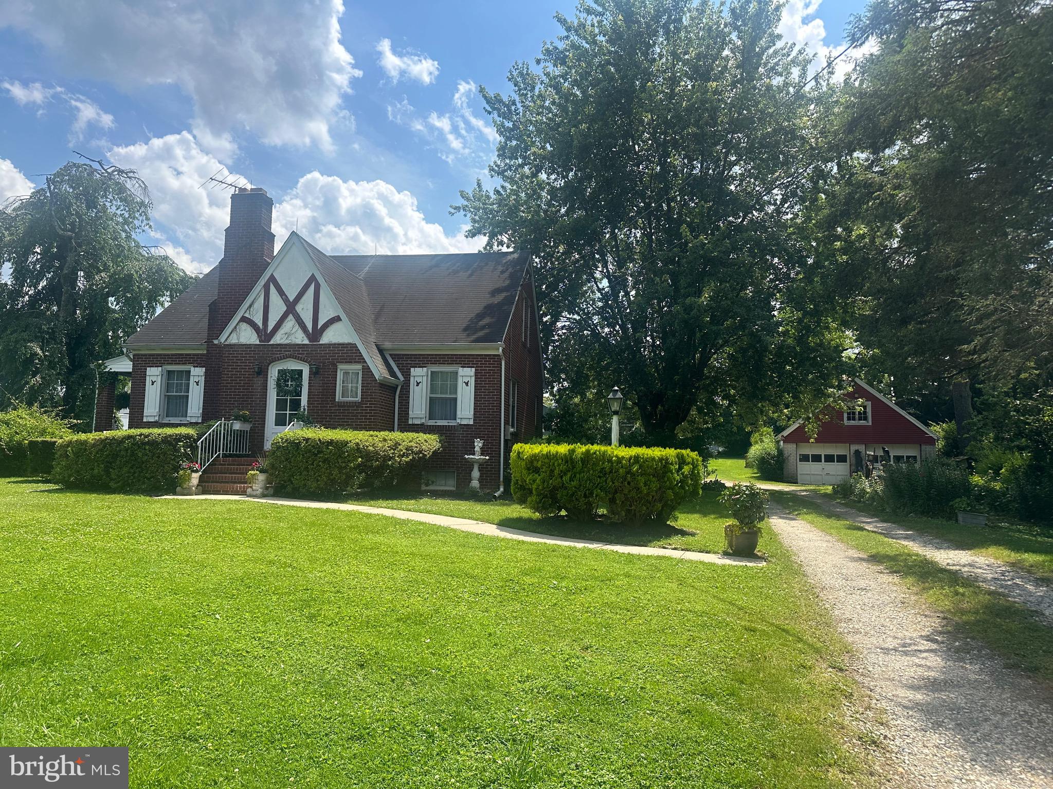 Highly Sought-After Kingsville Brick Cape Cod and additional separate .626 acre lot are being sold together as one. House is Tax ID: 04111108065575. Additional, adjoining .626 acre lot is Tax ID: 04111108065576. Finished square footage of dwelling may be greater than recorded in public records, as the upper level space was finished.
This charming Cape Cod in the heart of Kingsville offers timeless appeal with 3 bedrooms, a bonus room, and 1.5 baths. Beautiful hardwood floors run throughout the home, adding warmth and character. The inviting living room features a classic wood-burning fireplace, while the formal dining room includes a custom-built corner cabinet. Arched doorways enhance the home's architectural charm. Enjoy your morning coffee on the covered side porch overlooking the gardens, or make use of the covered rear porch, conveniently located off the kitchen—perfect for unloading groceries. Additional highlights: a front row seat for the Kingsville July 4th parade, walk-up basement access to the spacious rear yard; detached oversized garage with second-level storage; chicken coop and an additional small shed. Sale includes an additional .626-acre lot, creating an ideal opportunity for a mini homestead, garden expansion, or recreational use. This property offers endless possibilities for those seeking a project. Sellers prefer to sell "as is". Space, charm, and a touch of country living— available right in Kingsville.