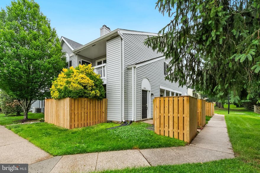Designed with a private ground-level entrance that delivers an upscale townhouse feel, this home welcomes you with an open, airy floor plan highlighted by dramatic vaulted ceilings, significant natural light and a classic wood-burning fireplace in the main living space. The adjoining dining area flows seamlessly into a bright, eat-in kitchen complete with freshly painted cabinets, stainless appliances, luxury vinyl flooring, and a private balcony. The main level features a versatile secondary bedroom situated directly across from a modernized full hallway bath, offering an ideal setup for an overnight guest suite or a quiet work-from-home office. The primary bedroom features a walk-in closet and its own updated ensuite bath. Additional features include LED lighting, several newer windows, in-unit washer and dryer, and an updated water heater (2022). Nestled in a highly desirable neighborhood, residents enjoy premium community amenities including an outdoor swimming pool, tennis courts, a private clubhouse/party room, picnic spaces, and miles of scenic jogging and biking paths. Best of all, this prime location places local dining, shopping, the post office, and the Olney Public Library right outside your front door.