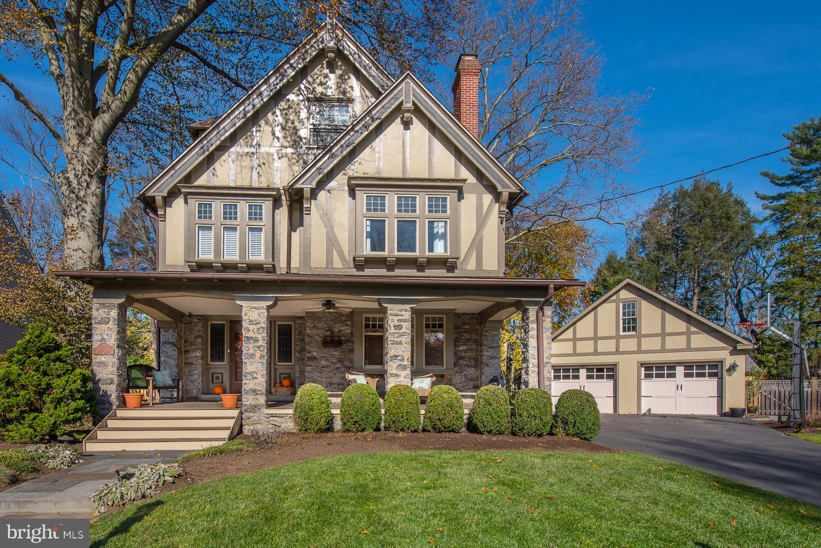 Welcome to this elegant Tudor residence built for the centuries & not just for today. For the buyer who will not accept less than top quality, we proudly offer this lovely home featuring an Ipe wood oversized porch. This 5 bedroom, 3.5 bath home boasts amazing architectural details from the refinished original Chestnut woodwork, including window, doors, stairway & moldings. Every room is filled with classic memories of workmanship and pride. Enter through the stunning front door with stain glass windows to the large entryway with a beautiful wood staircase. The timeless woodwork continues into the charming living room complete with a gas fireplace. Through the pocket door, you will find the fabulous dining room with banquet seating along a large window and faux fireplace perfect for entertaining. The newly remodeled modern gourmet kitchen features honed Quartzite Countertops, large subway tile backsplash, farm sink, water filtration, and surround sound. The top of the line appliances includes four Wolf ovens. One oven is a combination oven with convection and steam that offers intuitive controls and consistent temperatures to ensure every meal is predictably remarkable. There is an oversized sub-zero refrigerator/freezer, plus two extra refrigerator drawers built to look like cabinet drawers. A Bluestar 6-burner stove, plus griddle, for the discerning home chefs who demand restaurant-quality results. The kitchen is also complimented with a built-in wine refrigerator and a spacious breakfast area that opens to an enormous family room with vaulted ceiling, a gas fireplace & built-in cabinetry. Exit through pocket doors from the family room to a PRIVATE covered outdoor stone patio oasis with stone wood-burning fireplace and built-in grill - ideal for entertaining all year round. The first floor is complete with a spacious and remodeled mudroom with radiant heat floors, three cubies with bench, powder room, and pantry with plenty of storage. Both front and back staircases lead you to the second floor with three bedrooms and a large laundry room with linen closet. The master bedroom features surround sound, new hardwood floors, large walk-in closet with high ceilings, and a space that can be used as a dressing room, office, or gym. The new master bathroom has honed marble radiant heat floors, two sinks, a shower, and a freestanding tub. Two other generous size bedrooms and an updated hall bath complete the second floor. On the third floor, you will find a large bedroom with a remodeled ensuite bath with a big closet and a 2nd bedroom perfect for guests and privacy. The finished lower level is perfect for a playroom, gym, or movie night and has plenty of extra storage. New roof put on in 2018. Backup generator services the entire house. Conveniently located to Center City and walk to Suburban Square for great shopping and dining, plus award-winning Lower Merion School District!!