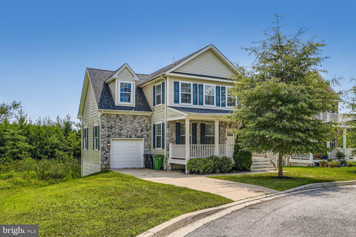This beautiful colonial is tucked away, on a quiet culdesac, welcoming you with a charming front porch and a stone-and-vinyl exterior. Step inside to a spacious living room featuring crown molding, recessed lighting, and gorgeous hardwood floors that flow seamlessly throughout the main level. The gourmet kitchen is a chef’s dream, boasting pendant lighting, a center island with breakfast bar, modern backsplash, 42” cabinetry, stainless steel appliances, and Corian countertops. Upstairs, retreat to the primary suite complete with plush carpet, triple closets (including a walk-in), a double vanity, and a ceramic tile shower with glass door. Additional bedrooms offer comfort and flexibility for guests, family, or home office space. The fully finished lower level provides a large family room, office, and full bath—perfect for entertaining, relaxing, or working from home. Enjoy the convenience of an attached garage and a driveway for additional parking. Located near major commuter routes, shopping, dining, and more.