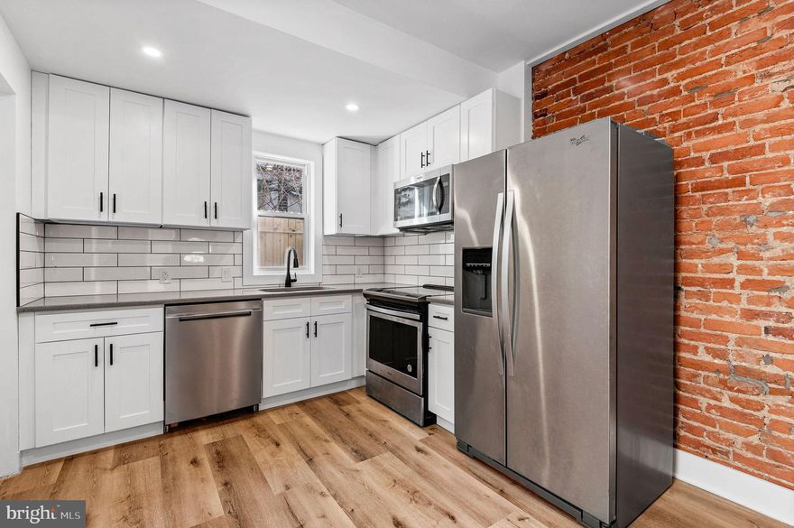 Welcome to 2553 N Sartain St, a meticulously renovated 3 bedroom 1.5 bath home located in a developing area in Philadelphia. All updates masterfully executed along with new roof, electrical, plumbing, and HVAC providing easy management and peace of mind. As you enter you're welcomed by an open concept living area, exposed brick which adds a unique character and warmth to the space, stunning luxury vinyl flooring and recessed lighting throughout. The first floor includes a convenient half bath and and a modern kitchen equipped with white shaker cabinets, subway tile backsplash and stunning quartz countertop, and stainless steel appliances. Upstairs you'll find three bedrooms and a luxurious bathroom with waterfall shower head . The unfinished basement provides tons of storage with the option for you to finish the space if desired.
