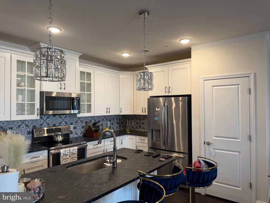 Experience luxury living at its finest in this exquisite 2-bedroom, 2-bathroom condo nestled within Birchwood at Brambleton, a distinguished (55+) community in Northern Virginia. Step into a world of modern elegance with stainless steel appliances, fresh paint, and hardwood floors accentuating the open floor plan. The kitchen boasts white upgraded cabinets, pendant lighting, a stylish backsplash, and steel gray brushed granite countertops, creating a culinary haven for any gourmet enthusiast. This stylish condo for sale offers the convenience of a spacious laundry room in the unit, making laundry days hassle-free and effortless. Unit 410 offers unparalleled comfort with a top-floor location, private balcony, and a dedicated private garage (G21) that is fully finished. Birchwood at Brambleton caters to your every need with a plethora of amenities, including clubhouse access, indoor and outdoor pools, bocce and pickleball courts, a fishing pond, and even a golf simulator. Verizon Fios TV and High Speed Internet are complimentary with this unit. Beyond the confines of this luxurious enclave, discover the vibrant lifestyle of Loudoun County, from nearby wineries to weekend escapes in the Blue Ridge Mountains. Commuting is a breeze, with Metro’s Silver Line, Dulles International Airport, and major thoroughfares such as the Dulles Greenway and Dulles Toll Road just minutes away. Additionally, the condo features its own community/entertainment room conveniently located just across the hall from Unit 410, providing the perfect space for large gatherings and leisure. Don't miss this opportunity to embrace resort-style living in one of Northern Virginia's most coveted communities. Schedule your viewing today and elevate your lifestyle at Birchwood at Brambleton.