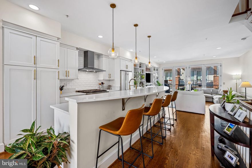 Welcome to 1324 Haubert Street, a remarkable 3 bedroom, 3 bath residence nestled in Locust Point’s highly sought-after Haubert Square. Crafted by Stonington Builders in 2006, this home is part of a select community of only ten properties which are known for their high ceilings, width and outdoor spaces on all levels.  If you are an organizational guru, this home is for you as it features an amazing amount of custom storage, built-ins and closet spaces throughout.
On the entry level  you’ll find a 2-car garage with a large alley behind, a laundry room, ample storage and a great 3rd bedroom with hardwood floors and a full bath.  The full-sized Murphy bed conveys, giving you so many options for a home office, den, gym or full on guest suite.
This home is an entertainer’s dream. The expansive open-concept living area offers so much natural light and versatility and features beautiful hardwood floors, expansive windows, and soaring high ceilings. The kitchen is a real stunner… featuring a large half-moon island illuminated by newly replaced pendant lighting, white quartz countertops and seating for 4.  Additionally, you’ll find upgraded appliances – including a range hood, built-in microwave, and wine fridge – along with ample Shaker-style cabinetry and a classic subway tile backsplash. The large family room features custom built-in shelving and double French doors that flood the room with light and seamlessly blend indoors and outdoors – where you’ll discover a sizable terrace with plenty of room for grilling and dining.
The third level features a large primary bedroom suite, again, with beautiful hardwood floors, custom closets, and a full bath with dual vanities, separate shower, and a soaking tub.  Another set of French doors allow you great access to the terrace and so much natural light.  A second bedroom, another full bath and an incredible custom walk-in closet complete this level.  
On the top floor, enjoy a stunning rooftop deck with a wet bar, offering panoramic views of the city skyline and the iconic Domino Sugar sign, hon! This exquisite home offers unmatched style, comfort, and convenience – all within proximity to the neighborhood’s vibrant parks, shopping, schools, dining and entertainment options. Don't miss your opportunity to own a piece of Locust Point's finest living.