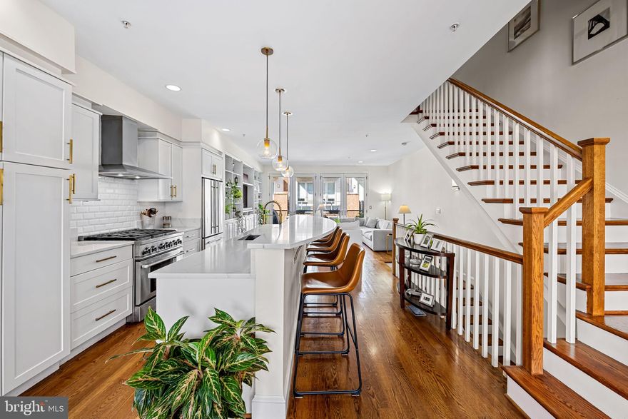 Welcome to 1324 Haubert Street, a remarkable 3 bedroom, 3 bath residence nestled in Locust Point’s highly sought-after Haubert Square. Crafted by Stonington Builders in 2006, this home is part of a select community of only ten properties which are known for their high ceilings, width and outdoor spaces on all levels.  If you are an organizational guru, this home is for you as it features an amazing amount of custom storage, built-ins and closet spaces throughout.
On the entry level  you’ll find a 2-car garage with a large alley behind, a laundry room, ample storage and a great 3rd bedroom with hardwood floors and a full bath.  The full-sized Murphy bed conveys, giving you so many options for a home office, den, gym or full on guest suite.
This home is an entertainer’s dream. The expansive open-concept living area offers so much natural light and versatility and features beautiful hardwood floors, expansive windows, and soaring high ceilings. The kitchen is a real stunner… featuring a large half-moon island illuminated by newly replaced pendant lighting, white quartz countertops and seating for 4.  Additionally, you’ll find upgraded appliances – including a range hood, built-in microwave, and wine fridge – along with ample Shaker-style cabinetry and a classic subway tile backsplash. The large family room features custom built-in shelving and double French doors that flood the room with light and seamlessly blend indoors and outdoors – where you’ll discover a sizable terrace with plenty of room for grilling and dining.
The third level features a large primary bedroom suite, again, with beautiful hardwood floors, custom closets, and a full bath with dual vanities, separate shower, and a soaking tub.  Another set of French doors allow you great access to the terrace and so much natural light.  A second bedroom, another full bath and an incredible custom walk-in closet complete this level.  
On the top floor, enjoy a stunning rooftop deck with a wet bar, offering panoramic views of the city skyline and the iconic Domino Sugar sign, hon! This exquisite home offers unmatched style, comfort, and convenience – all within proximity to the neighborhood’s vibrant parks, shopping, schools, dining and entertainment options.