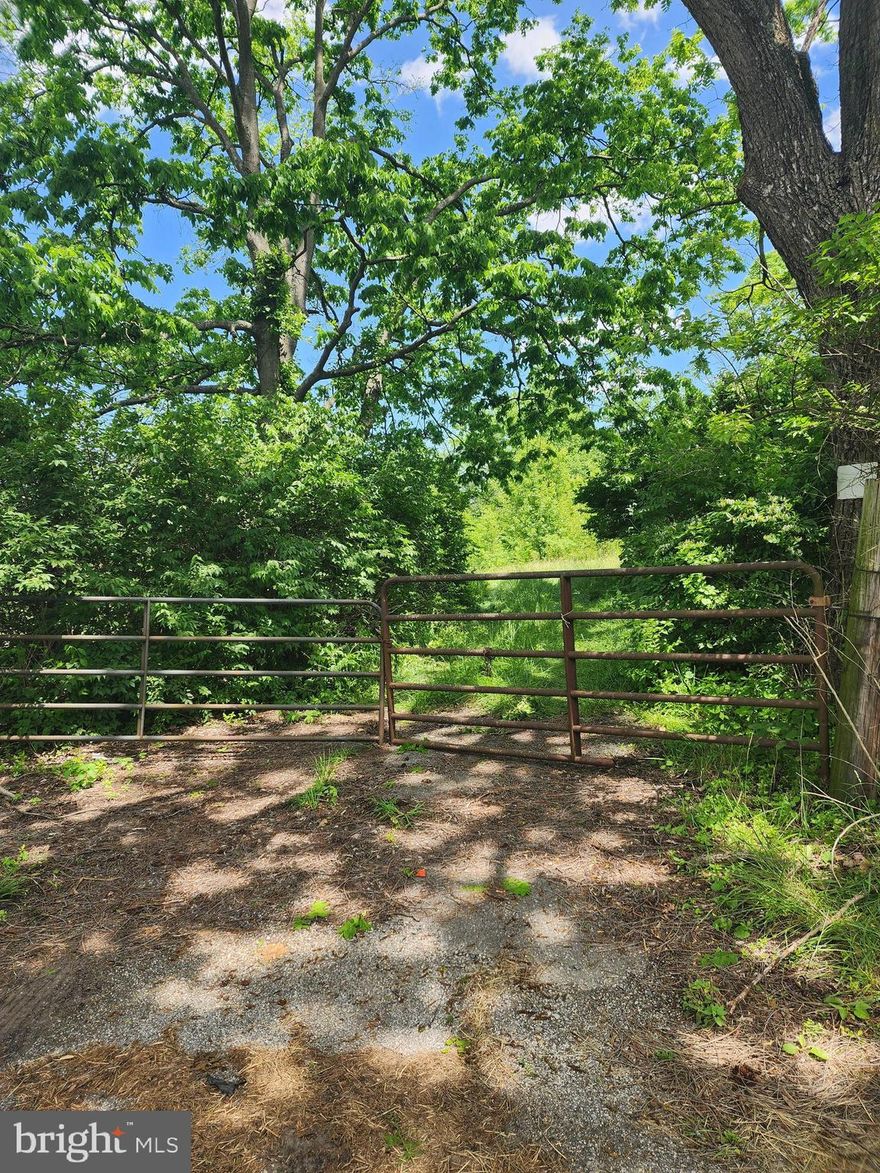 What a great find! This lot is just over 10 acres in a very Rural setting yet close to Interstates and amenities. It is just outside of Funkstown, on Old National Pike not to far from the I-70 Overpass. It's a long narrow lot with lots of privacy on the borders with tress and fencing and most of it is open ground, though there are some young trees/growth. Years ago the property was used for cows by previous owners, and there is a shed still standing  (in disrepair).There was a well drilled behind the shed in 1977 that was for the cows and as not been used in years. The Health Dept confirmed there was a perc done in 1987 that tested at 30 minutes though it may require a "mini" perc soil survey for a future septic system.  Seller is not aware of any restrictions. The land is considered part of "Rocky Spring EXTD". Buyer to verify all info and condition of well.  It is a super nice property with rolling hills, though plenty of level spots that would be great to build a home on.  Current owner had plans to build on it, but instead  used it for gardening and kept as an investment. There are nice established berry bushes in a fenced area in front of the shed  Reach out to agent for viewing options.