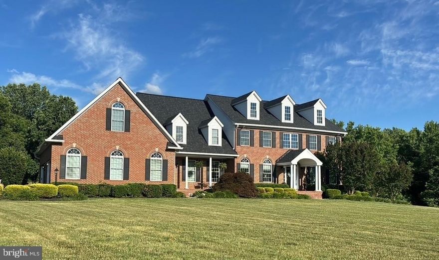 Lined with mature trees and backing to a peaceful stream, this stunning home offers the perfect blend of luxury, comfort, and everyday livability across 7 beautiful private acres. The setting feels like a private retreat, yet it’s still conveniently located for commuting with easy access to major routes. From the moment you arrive, the home makes an impression with its stately presence, two front entrances, and oversized three-car garage with storage above. Inside, you’ll find timeless details throughout, including wainscoting, crown molding, custom built-ins, and detailed woodwork that add warmth and character without feeling overdone. The main level is designed to make daily life easy while still feeling special enough for entertaining. The formal living and dining rooms are perfect for gatherings, while the enormous family room creates a comfortable place to relax, featuring both a fireplace and a pellet stove. The gourmet kitchen is truly the heart of the home, offering a large workspace, quality appliances, and an insta-hot faucet for added convenience. Just off the kitchen, the bright breakfast room and rear deck provide the perfect spots to enjoy morning coffee while taking in views of the trees and surrounding acreage. There’s also a first-floor office that could easily serve as a main-level bedroom if needed, along with a spacious laundry room featuring extra cabinetry, washer, dryer, and a laundry tub. Upstairs, each of the four bedrooms feels like its own private retreat, all featuring en-suite baths and great storage. The primary suite stands out with its huge sitting area, spa-style bath with soaking tub and separate shower, and incredible closet space designed to hold everything with room to spare. The mostly finished basement adds even more living and entertaining space with a large recreation room, entertaining area, and a cozy wood-burning stove with a classic brick hearth and mantle. Walk-out access leads directly to the backyard and pool area, making indoor-outdoor living feel seamless. There’s also an unfinished exercise space, tons of storage, and a rough-in for a future bathroom. Outside is where this property truly shines. The gunite pool creates a resort-like feel during the warmer months, and the hot tub is included as-is. The detached 30x40 barn-style building with concrete flooring offers endless possibilities for a workshop, hobby space, or storage. The partially wooded acreage offers privacy, natural beauty, and ample space for horses, if desired. Additional features include a water filtration system and a Generac generator hook-up already in place and being wired. Located in a small subdivision with no HOA, this property offers the freedom and space that’s becoming harder to find.This is the kind of home where everyday living feels a little more special, where entertaining is easy, and where years of memories are waiting to be made. A truly beautiful property inside and out.
** Senior pets on premises. They will be in the garage for initial showings, but can be removed for 2nd showings & inspections