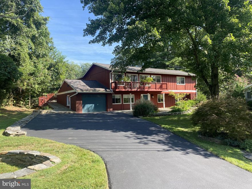 Prepare to fall in love when you walk through the front door! Rare opportunity in Potomac on large .37 acre lot in the Churchill school district! This fabulous, four bedroom, three bath one-of-a-kind home with garage has been renovated top to bottom with many custom details and surprises throughout. Gorgeous designer kitchen, three beautiful high end designer bathrooms, kitchen dining area and family room bump out with new sliding glass doors to back deck with pergola, flagstone patio, Trex deck with built in stainless steel commercial gas grill and Sundance hot tub overlooking private fenced yard and field beyond. The entry level features a family room with custom millwork, tile floor, recessed lighting, and fireplace with wood burning stove insert, bedroom/home office with custom walk-in closet with frosted French doors and built in window seat/bench, beautiful full bath with custom tiled walls,  walk in shower, and vanity with soapstone top, and  laundry room with wall of cabinets, quartz countertop, sink and  Maytag Bravos XL commercial technology washer and dryer. Contemporary stairs with landing, fabulous ceiling light fixture and glass block inserts take you to the main level which will wow you even more than the entry level. The  main level features a light-filled living room with soaring ceiling and new sliding glass door to charming balcony, spacious dining room and family room with recessed lighting, ceiling fan and sliders to back deck. The eat in kitchen is a chef’s dream with custom cabinetry with lighted upper cabinet, undermount lighting, granite countertops, GE Café series refrigerator, six burner GE Cafe gas range with double ovens, Fisher Paykel two drawer dishwasher, built in microwave and dining area with slider to deck. The primary suite has a king-sized bedroom with large picture window, large closet, walk in closet and dream spa bath with exquisite tile work, oversized walk in shower with tile bench, shelf, and wall niche and double vanity with quartz countertops. The large second bedroom on the main level has a walk-in closet with custom shelving and custom window bench alcove with storage. The third main level bedroom has custom closet. The beautiful, renovated hall bath has stunning  tile work. Wonderful curb appeal with welcoming expansive front flagstone patio accented with stone walls. Other notable features include over $6,000 in custom window treatments, professional landscaping, hardscaping, and French drain system in rear,  Newer architectural shingle roof with 50 year shingle. Newer HVAC, hot water heater. Nothing to do but move right in and enjoy your private oasis in Potomac.  Please see all photos and floor plans. Welcome home!