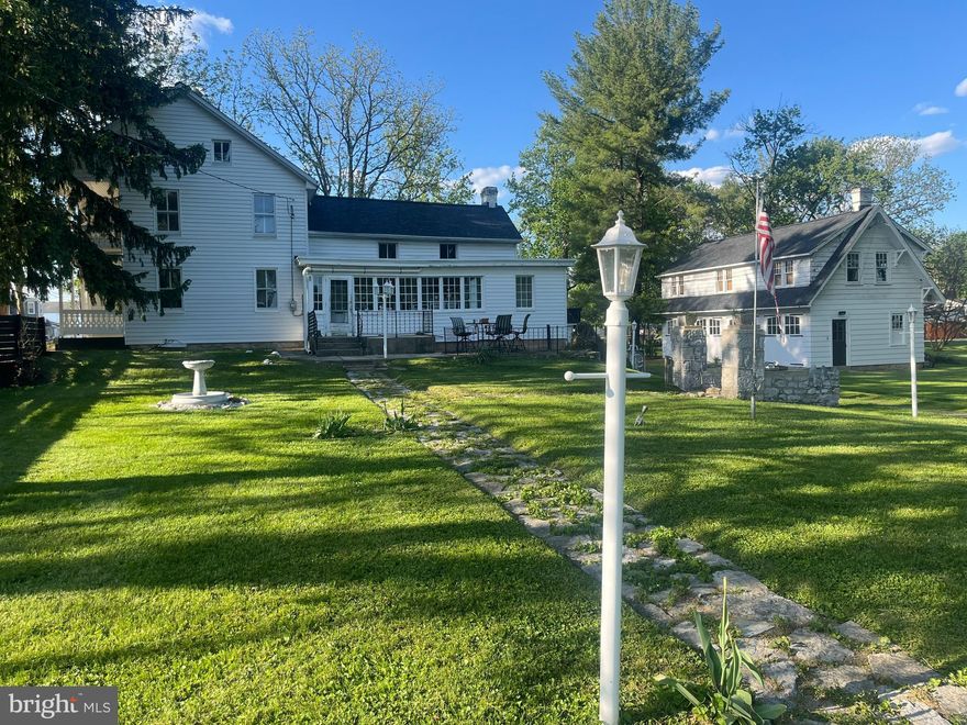 Absolutely CHARMING! This 1886 colonial has been lovingly maintained and renovated. Main level living room, enlarged kitchen leading to gorgeous sun porch, bedroom, and 1.5 baths. Upstairs has 1 full bath and 4 more bedrooms (one walk-thru which opens onto beautiful, shaded balcony with a porch swing). Walk-up attic with hardwood floors is HUGE and could be finished for additional living space. 1 ACRE lot with circular drive and 4 CAR GARAGE with walk-up loft = endless potential! 3 heat pumps, new roofs, new kitchen floor, fresh paint, and newer appliances. Convenient location, perfect for commuters: I-81 & I-70 interchange, Hagerstown Regional Airport, UNI & Meritus Urgent Care, Walmart, Martins, Sheetz, McDonald's, CVS, Walgreens, firehouse, schools, and post office all within 3 miles. MUST SEE!