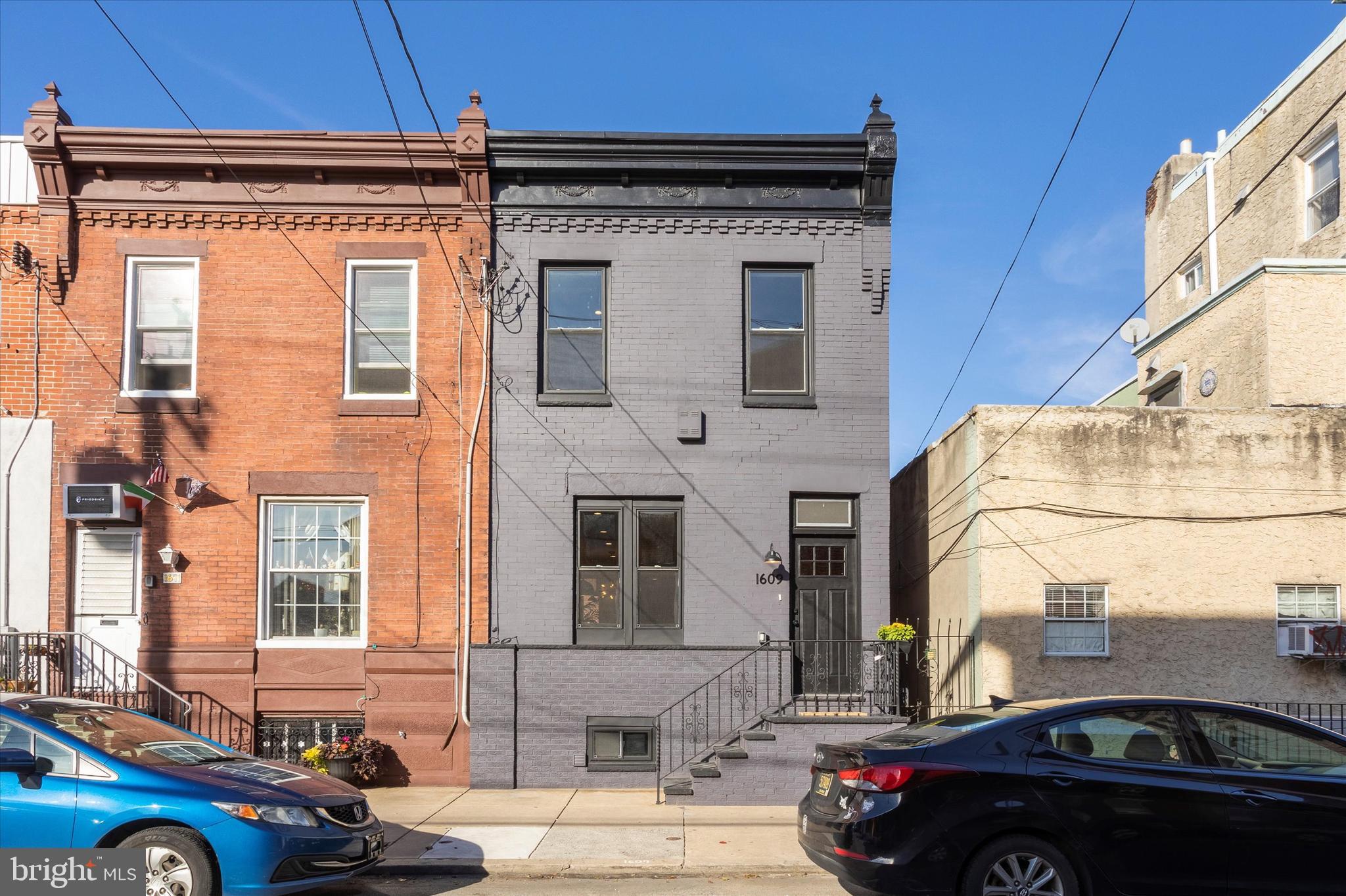 Stunning Mid-Century Modern, end of row townhome with extremely high ceilings, and an abundance of light and air. Located in the heart of Newbold in South Philly. Check out this beautifully renovated home which features a modern open floor plan, exposed brick, engineered hardwood floors throughout and gorgeous light fixtures dropping down from strikingly high ceilings. The Chef’s Kitchen features stainless appliances, sleek, soft close cabinetry with ample storage and pantry space, quartz counters with a free standing island, a glass subway tile backsplash and stunning wallpaper. On your way to the rear patio you will find a mudroom complete with washer and dryer, and a convenient half bath, both finished with modern muted tile designs. The private rear patio is a peaceful haven for the owners, featuring privacy and potted gardening. Upstairs you’ll find 3 spacious bedrooms, a primary en-suite featuring modern tile design, a gorgeous vanity and seamless glass enclosed shower. A finished basement provides ample space for a home office, rec room, and plenty of room for organized storage. New plumbing, electric, water heater, HVAC and ductwork, insulation and paint throughout. This home is a must see on a great block with excellent walkability. Tax abatement is pending. 2 owning members of the LLC are PA licensed realtors, one being the listing agent.