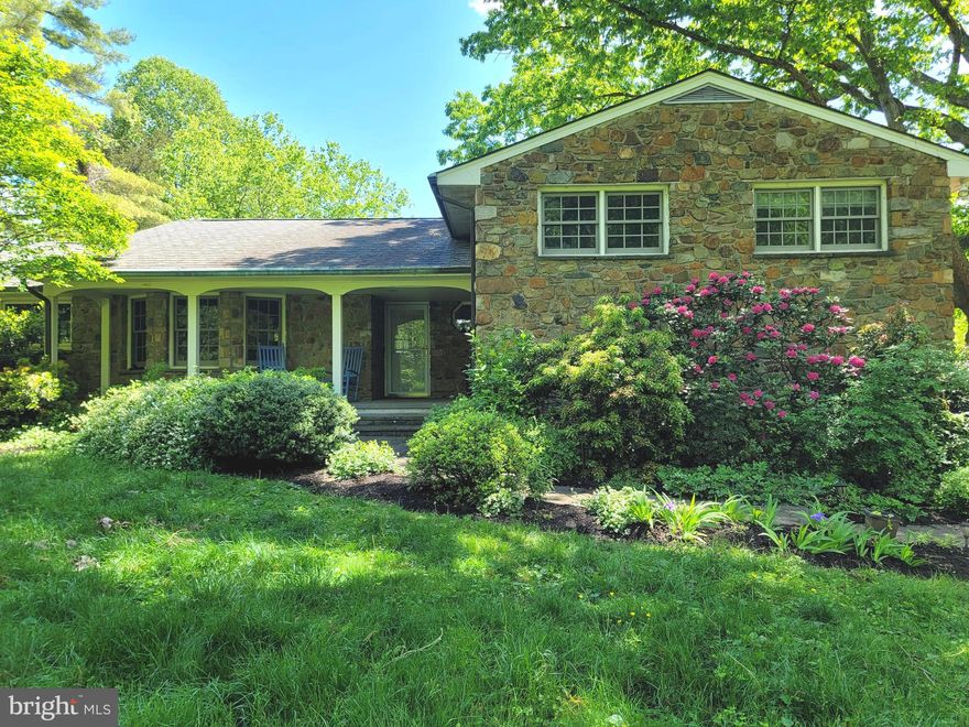 Welcome to 8415 Lees Ridge Road! This lovely W. J. Hanbeck-inspired fieldstone home is a bucolic treasure of stone walkways, English gardens, cascades of flowers, wildlife, and the elegant countryside that Lees Ridge offers. Driving from Old Town Warrenton, your ride down Lees Ridge Road consists of incredible mountain and valley views, estate homes, and charming cottages. Nestled among them is this gem of quality built stone home with 3 scenic acres, 3 bedrooms, and 2 and one half updated bathrooms. 

Check out the gourmet kitchen! Upgraded cream cabinets with granite countertops, walk in pantry, several new stainless steel appliances..and the best part - gas cooking! Plenty of room for entertaining here! Formal dining room, living room, and huge partially covered deck overlooking the scenic gardens and property. The living room has a wall of windows and a gorgeous stone fireplace. A few steps up on the bedroom level is a primary retreat with a walk-in and one additional closet, as well as an en-suite bathroom with a new vanity and walk-in shower.   The two other generous-sized bedrooms share a hall bathroom with a new vanity and tub shower.    The living room, dining room, hall, and all three bedrooms have original hardwood floors. A beautiful family room on the lower level with French doors leading out to the gardens. This room also has a wonderful stone fireplace and built-in shelving and storage. On this level is also a convenient 1/2 bathroom and the entry to the oversized two-car garage with a built-in workbench and shelving. There is also an unfinished basement room for additional storage and mechanicals. There is a nice shed for all your gardening tools for outdoor storage.   Lastly, don't forget to sit a spell on the dreamy covered front porch with some winter mountain views and incredible flowering dogwoods, rhododendrons, and a vast variety of perennial flowers in the spring.   Schedule your appointment today to see this majestic home!