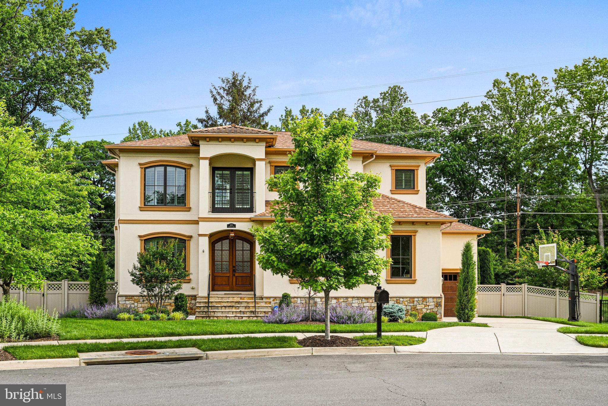 Welcome to 920 Ninovan Road Southeast, a sophisticated Mediterranean-inspired residence nestled in the heart of Vienna, Virginia. Located on an oversized cul de sac surrounded by similar homes this property boasts 5 bedrooms and 5.5 luxurious bathrooms, this sprawling 6000+ square foot home backs to the W&OD trail and offers plenty of amenities including hardwood floors and 10-foot ceilings and built ins throughout. The gourmet kitchen is a chef's dream, featuring exquisite granite countertops and Thermador stainless steel appliances and ample cabinets. The open floor plan seamlessly connects to an expansive deck with a dual sided fireplace, providing an ideal setting for outdoor entertaining and relaxation. Retreat to the owner's suite, where a spa-like bathroom awaits, complete with heated floors and a coffee bar. One of only a few 3 car garage homes built in the town of Vienna this property has it all, don't miss this rare opportunity.