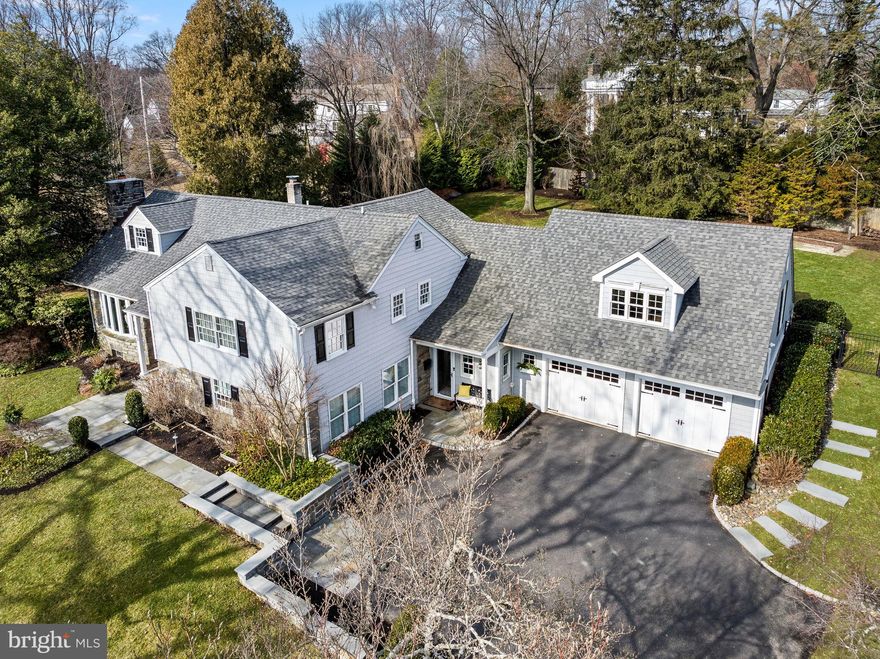 Step into timeless elegance with this beautifully appointed 4-bedroom, 3.5-bathroom home on a stunning .70 acre lot in the coveted neighborhood of Strafford Village, walkable to the train and downtown Wayne. This updated and meticulously maintained home exemplifies classic charm meets modern luxury. An extensive renovation in 2016 designed by marshall sabatini architecture and executed by Orion General Contractors included the first floor and kitchen, the primary suite, two additional full bathrooms and the exterior hardscaping and landscaping.
A picturesque bluestone path and inviting front porch lead to a stunning custom wood front door by Wolfe & Hale, setting the tone for the exquisite craftsmanship within. Inside, the foyer impresses with rich random width hardwood floors, wainscoting and crown molding, creating a warm and sophisticated welcome. On the left, the living room boasts a bow window (new Pella Architectural Series in 2018), recessed lighting, and a striking stone fireplace with new mantle, offering the perfect space for gathering. Seamlessly flowing into the chef’s kitchen, you'll find custom inset cabinetry by Village Handcrafted, a sideboard with a mix of black leathered granite and wood flanked by pantry closets, a large island of honed granite with farmhouse sink, two glass globe pendant lights and seating for four. Top-of-the-line Viking stainless appliances including a 6-burner range with a vented hood, dishwasher, refrigerator and built in microwave. Random width pegged hardwood floors complete the space.Take two steps down into the dining room, where a wall of windows overlooks the private backyard. Thoughtfully designed with a beadboard ceiling, built-in sound system, original slate stone floors, and a stylish drum light fixture, this room is ideal for both family dinners and grand entertaining. A glass door provides access to the bluestone and brick patio (repointed in 2024) with a stone seating wall, leading to a professionally landscaped fenced yard. Back inside, a few steps down from the foyer and through glass french doors is a spacious Family Room (currently used as an office). Nearby is the large laundry room with beautiful cabinetry and a convenient private powder room. Head into the two story mudroom with an exposed stone wall, custom built-in cubbies, a family entry door to the front and access to the oversized 2-car garage with a full wall of cabinetry.
Take the turned staircase to the stunning Bonus Room with a cathedral ceiling accented with wood beams, beadboard walls, a full height stone fireplace (gas), and a built-in window seat, perfect for recreation, workouts, or movie nights. The beautifully refinished hardwood floors continue on the second level, where the primary suite is a true retreat, featuring recessed lighting, a fully outfitted walk-in closet, and a completely renovated ensuite bathroom with a carrera topped double vanity, oversized shower and a private water closet. Two additional bedrooms share a full hall bath with a tub-shower combination accessed from the hall and through a pocket door in the 2nd bedroom. The third bedroom—currently used as an office—boasts built-in shelving and a double-door closet. The spacious landing includes a linen closet and a second, larger storage closet.
The third floor hosts a generously sized fourth bedroom and a well appointed bathroom features marble flooring and shower surround. Attic space on this level provides plenty of storage. 43 Crestline is located in a special neighborhood: Strafford Village, a registered Civic Association that offers many annual events; Spring Thing Cocktail Party, Fourth of July Parade and Picnic, Progressive Dinner, Holiday Party, Playgroups, Book Clubs, and more. Moreover, this residence is serviced by the Tredyffrin-Easttown School District. Less than a half-mile from the Strafford train station, this home also offers convenient access to major routes making commuting a breeze.