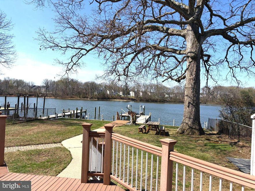 Live like you are on a permanent vacation!  Enjoy the pleasures of true waterfront living with this 3 BR home located on Middle River. On the main level you will find an entry foyer, laundry room/half-bath combo, eat-in kitchen, breakfast/dining room, formal living room & more.  The focal point of the main level is the awesome sunroom that captures the stunning sunsets, & the breathtaking river views year-round! The upper level has three bedrooms & updated full bath.  Once outside, relaxing on the large deck w/your morning coffee or evening cocktail, or sitting on the edge of the pier greeting boaters passing by will be your daily routine. This unique property features a 2-tier bulkhead in 2022; pier decking/restructuring in 2024; new water & electric to pier in 2024; 10,000 lb. magnum boat lift w/remote control;  2 manual davits on pier for jon boat or jet skis.  There is a 10 x 10 vinyl sided shed at the rear of the property & 5 x 8 shed on the waterfront side for storage of all your water toys & lawn & garden items.  Newer features include a 50 gal.water heater in 2023; roof on home & 10 x 10 shed in 2022 including gutters, downspouts, leaf guards, chimney flashing, skylight; refrigerator in 2024; water heater in 2023; 200 amp electric service.  Water depth at low tide is approximately 7' at end of pier.  Property sits almost 11 feet above normal tide, & was not impacted by Hurricane Isabel in 2003.  There is plenty of parking in the rear for guests on the parking pad which supports 3 vehicles & a stone pad for a boat trailer; a separate parking spot is available within the fenced area of the rear.  Additional bonus - no flood insurance required!  A true waterfront retreat yet moments from all the amenities of suburban living.  Make your move now and get your water toys ready for the summer of 2026!