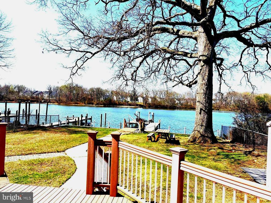 OPEN SATURDAY 12-2 and SUNDAY 10am-12pm.  Live like you are on a permanent vacation!  Enjoy the pleasures of true waterfront living with this 3 BR home located on Middle River. On the main level you will find an entry foyer, laundry room/half-bath combo, eat-in kitchen, breakfast/dining room, formal living room & more.  The focal point of the main level is the awesome sunroom that captures the stunning sunsets, & the breathtaking river views year-round! The upper level has three bedrooms & updated full bath.  Once outside, relaxing on the large deck w/your morning coffee or evening cocktail, or sitting on the edge of the pier greeting boaters passing by will be your daily routine. This unique property features a 2-tier bulkhead in 2022; pier decking/restructuring in 2024; new water & electric to pier in 2024; 10,000 lb. magnum boat lift w/remote control;  2 manual davits on pier for jon boat or jet skis.  There is a 10 x 10 vinyl sided shed at the rear of the property & 5 x 8 shed on the waterfront side for storage of all your water toys & lawn & garden items.  Newer features include a 50 gal.water heater in 2023; roof on home & 10 x 10 shed in 2022 including gutters, downspouts, leaf guards, chimney flashing, skylight; refrigerator in 2024; water heater in 2023; 200 amp electric service.  Water depth at low tide is approximately 7' at end of pier.  Property sits almost 11 feet above normal tide, & was not impacted by Hurricane Isabel in 2003.  There is plenty of parking in the rear for guests on the parking pad which supports 3 vehicles & a stone pad for a boat trailer; a separate parking spot is available within the fenced area of the rear.  Additional bonus - no flood insurance required!  A true waterfront retreat yet moments from all the amenities of suburban living.  Make your move now and get your water toys ready for the summer of 2026!