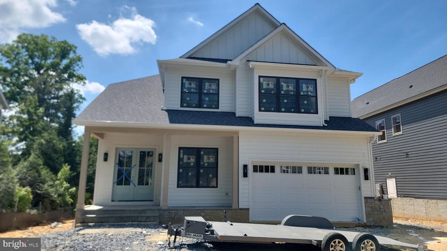 Experience luxury living at its finest in this spectacular new construction on 6th ST N, in Arlington’s sought-after Brandon Village neighborhood. A spectacular Kane Home Design & Build product! From the grand foyer, you’ll immediately notice the soaring ceilings on all three levels, expansive black-frame windows that flood the home with natural light, and wide-plank white oak floors that set a warm, elevated tone throughout. Designed for both everyday comfort and unforgettable entertaining, the main level features an extraordinary open layout with a showstopping gourmet kitchen—complete with an oversized island with seating, premium stainless steel appliances, an expansive walk-in pantry, and a sunny breakfast nook with access to the rear deck. The adjacent family room offers a cozy gas fireplace, while the separate formal dining room with coffered ceilings is perfect for hosting. A versatile main-level office/bedroom includes a closet and ensuite full bath. You’ll also love the thoughtfully designed mudroom with built-ins, sink, and full-size laundry, offering dual access from the interior and the oversized two-car garage. Upstairs, retreat to an impressive primary suite with cathedral ceiling, sitting area, mini bar, and two walk-in closets. The spa-inspired bath is straight out of a magazine—double vanities, dual showers, and a soaking tub for the ultimate unwind. The secondary bedrooms are beautifully planned: two share a Jack-and-Jill bath, while another enjoys a private full bath. A second upper-level laundry room with cabinetry and counter space adds everyday ease. The walk-out lower level is an entertainer’s dream with a spacious recreation room, large wet bar, dedicated fitness area, and a sixth bedroom with full bath—ideal for guests. Step outside to a fenced backyard with pavers, perfect for relaxing or hosting.