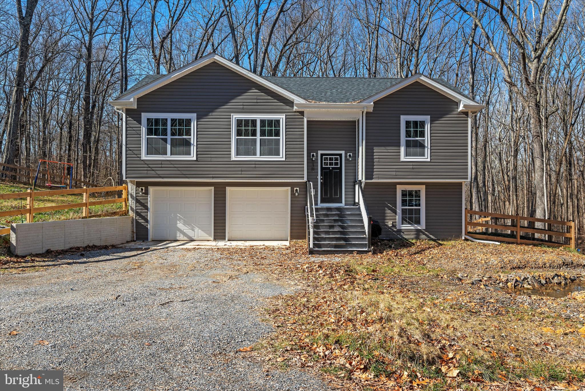 Nearly new split foyer with three bedrooms and three full bathrooms on three cleared lots totaling 1.47 acres. Luxury vinyl plank floors in the living areas for easy maintenance and plush carpeting in all bedrooms for comfort! On the upper level you will find the primary bedroom suite with attached bath on one end, and two bedrooms that share a full hall bath on the other. Enjoy views of the unspoiled forest from the open concept living room, kitchen and dining combo. The kitchen has been upgraded with granite countertops, stainless-steel appliances, and an island with breakfast bar seating. The lower level includes an entertainment area, another full bathroom, and a walk-out to the fully fenced yard. This property backs to the Wildlife Management Area and is near the river for great hiking and fishing. The large fenced yard provides ample space for play, while the spacious lot provides privacy and beauty. Located near commuter routes to Northern Virginia and Maryland and yet tucked off the major thoroughfares, this home can be a fabulous residence, or your home away from home!