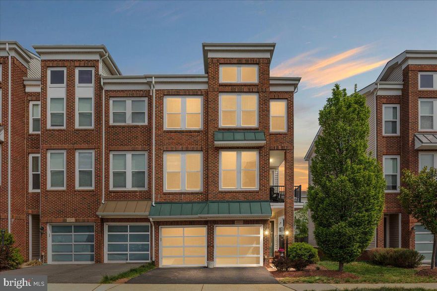 The very Best of Brambleton! Expansive (3263 sq ft!) end-unit garage townhome with a unique contemporary floorplan designed for modern lifestyles, including ENTRY LEVEL main living areas - no more walking up stairs right when you get home! The main level boasts 5" wide plank engineered wood floors and an open concept designed to enhance connections or make entertaining a breeze. Spacious family room with gas fireplace flows into the adjacent dining area and the gorgeous gourmet kitchen - featuring oversized center island, sleek white cabinetry, granite counters, and stainless steel appliances (check out that gas cooktop with ceiling mounted range hood and recently replaced dishwasher too!). Glass door leads out to a picturesque fully fenced rear yard with an updated paver patio made for flipping burgers and summer gatherings.  Upstairs an idyllic primary retreat awaits you, with sitting room, tray ceiling, dual walk-in closets, and luxury bath with separate vanities, soaking tub and stall shower. Upper Level One is also home to a convenient laundry room featuring recently replaced washer and dryer, sunny balcony (your morning coffee is calling!) and a fantastic flex space - perfect for a home office or den. Upper Level Two features a second bedroom suite the family will fight over, 2 additional bedrooms, full hall bathroom, and a large loft - you could purpose this space as a play or homework room, teen hangout, gaming area, or gym! Brambleton is a favorite Loudoun neighborhood for good reason: top tier amenities (pools, parks, playgrounds, sports courts, 20 miles of trails), community events throughout the year, enviable proximity to shopping / dining / movies / golf courses / library, and a monthly HOA fee that includes trash, cable, internet, and limited lawn care!! Plus a desirable location with easy access to Dulles Greenway, LoCo Pkwy, 28, 50 and the Ashburn Metro Station. This one has it all, and you can see for yourself soon - showing start Friday May 15th.  First open house Friday night 5pm-7pm, or see it Saturday May 16th from 1-3pm
