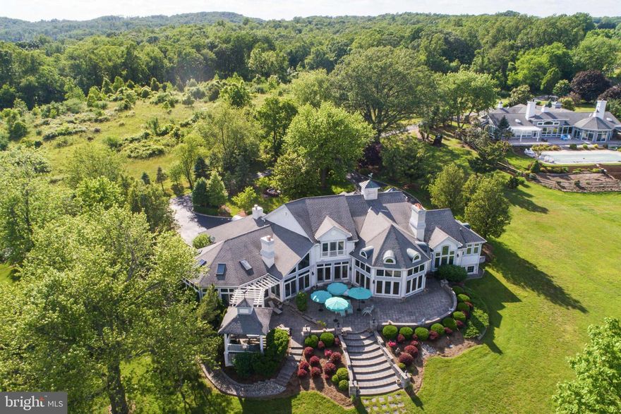 Welcome to Osprey Cove!  Panoramic views of the Elk and Bohemia Rivers are seen from this meticulously cared for waterfront home located among an enclave of 6 luxurious homes, nestled on 50+ acres. Well maintained by a full time caretaker.  Enjoy the privileges of a waterfront home. Whether hosting family and friends or enjoying a quiet moment on the spacious back patio, at the indoor pool or on your private pier, this home rises to every occasion.  Designed for entertaining on a grand scale.  This 7,000 + sq. ft. contemporary showcases fine living.  Appointed with 18' cathedral ceilings, floor to ceiling windows and an open floor plan that is streaming with natural light.  Gleaming hardwoods, stone fireplace, built-in bookcases, game room, heated master bath tile floor, formal terrace and professionally landscaped grounds.  3 car attached garage. Designed for low maintenance, energy-efficient living and offers luxury living year-round.  Welcome Home!