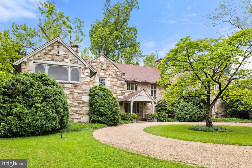 Glendonnell, Warrenton, VA, Is a Solid Stone Neo-Tudor residence recently featured on the Virginia Historic Garden Week Tour. The home was built in 1918 and exemplified early twentieth-century quality craftsmanship and detailed construction. Mature landscaping of boxwood, cherry, oak shade trees, shrubbery, and perennial gardens creates an oasis at this in-town location where one can walk to restaurants, shopping, library, and much more. Inside, a timeless spaciousness is captured with attention to design and finishes and built of a mix of coursed stone blocks, adding to the architectural style with thick masonry interior walls accented with red tile roof shingles.
The interiors feature ample light-filled rooms with a generous center hallway with four large arched doorways leading to the living room, dining room, and 2nd floor. Quality woodwork from another era includes hardwood floors, moldings, built-in cabinets, and mantels on five wood-burning fireplaces.
A generous kitchen with farm sink, granite countertops, custom cabinets, six burner gas cooktop with a warming drawer, and two wall ovens offer the gourmet cook all the amenities for efficient food prep. Adjacent to the kitchen is an additional half bath and a large laundry room. A rear staircase accesses the 2nd floor from the kitchen area. The flow and spacious dining and living rooms are perfect for an elegant entertaining ambiance galore with wood-burning fireplaces. Additional rooms, of the den or stone room. A separate office and gym on the first floor.
There are four bedrooms, two full and two hall baths on the 2nd floor. The primary bedroom has a fireplace, a large sitting room, a sleeping porch, and a private bath.
The home has a rear stone patio for outdoor generating—a detached garage with room for additional storage.
No drive-bys please.