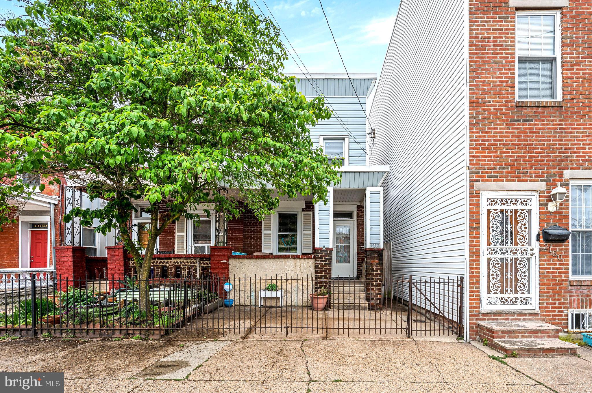 Located on one of the most desirable streets in Fishtown—recently named one of America's Hottest New Neighborhoods by Forbes Magazine—this sunny and bright twin home is truly a rare find. Enjoy the privacy and charm of a gated front yard, a cozy covered front porch, and your own rear courtyard, all with the added bonus of abundant on-street parking. Step inside to a sun-drenched, open floor plan featuring a spacious living room, a true dining area, and a beautifully remodeled kitchen. The kitchen boasts stainless steel appliances, generous cabinet and counter space, and a convenient counter seating area—perfect for entertaining. A mudroom addition houses first-floor laundry for added convenience. Upstairs, you'll find two large bedrooms, an impressively expanded and modern bathroom, and a spacious walk-in closet that’s sure to impress. One of the few homes in the area with a full-sized basement, there’s ample storage space throughout. Additional upgrades include newer windows, flooring, a commercial-grade roof, a newer furnace, and fresh paint throughout. Bonus: Seller is offering a $5,000 credit toward central A/C installation!