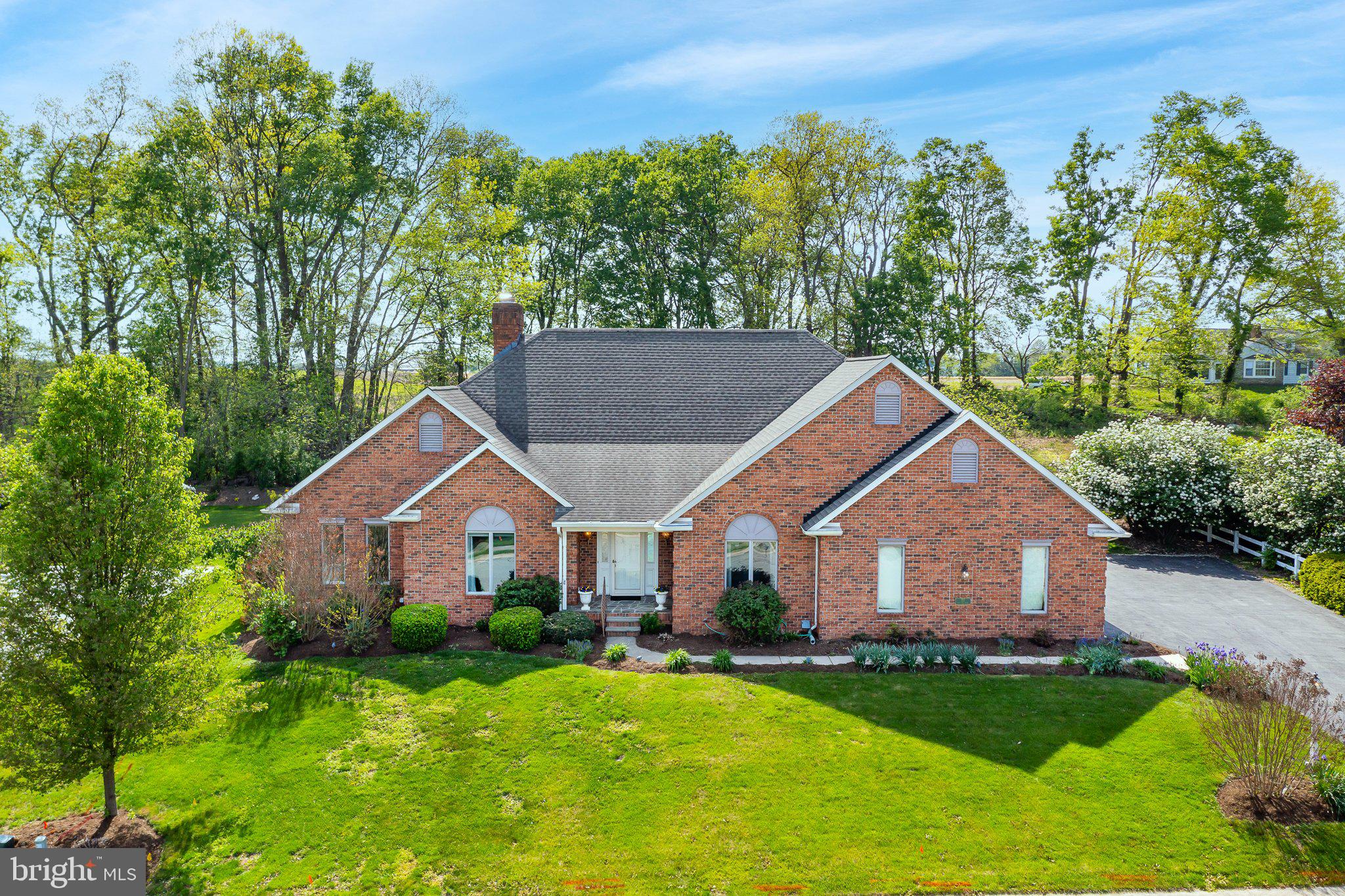 Welcome to refined one-story living in this custom-built brick rancher, nestled in a highly sought-after location with easy access to highways and daily conveniences. Situated on a beautifully landscaped lot with scenic farmland views, this home offers over 3,150 square feet of elegant living space—including a stunning 576 SF heated Veranda/Sunroom featuring stone floors, abundant natural light, four skylights, and Andersen windows and doors throughout. The thoughtfully designed floor plan features three spacious bedrooms with potential for a fourth bedroom or flex space in the finished loft. The primary suite is a true retreat with generous proportions and comfort. You’ll love the gleaming hardwood floors, formal dining room, and seamless flow of the main living areas. Outdoor and hobby enthusiasts will appreciate the oversized 3-car garage with openers, bonus walk-up storage, and direct stair access to the full basement—which includes roughed-in plumbing for a future bathroom and ample space for a workshop, home based business, or creative pursuits. Additional highlights include, efficient natural gas including a gas line for outdoor grilling, Electronic air filter on furnace for enhanced indoor air quality, A serene walled patio and fish pond, creating a peaceful backyard oasis. This previous model home offers luxury, functionality, and room to grow—all in the Penn Manor School District, with excellent proximity to Routes 30 and 283. Schedule your private showing today and experience the lifestyle this exceptional home has to offer.