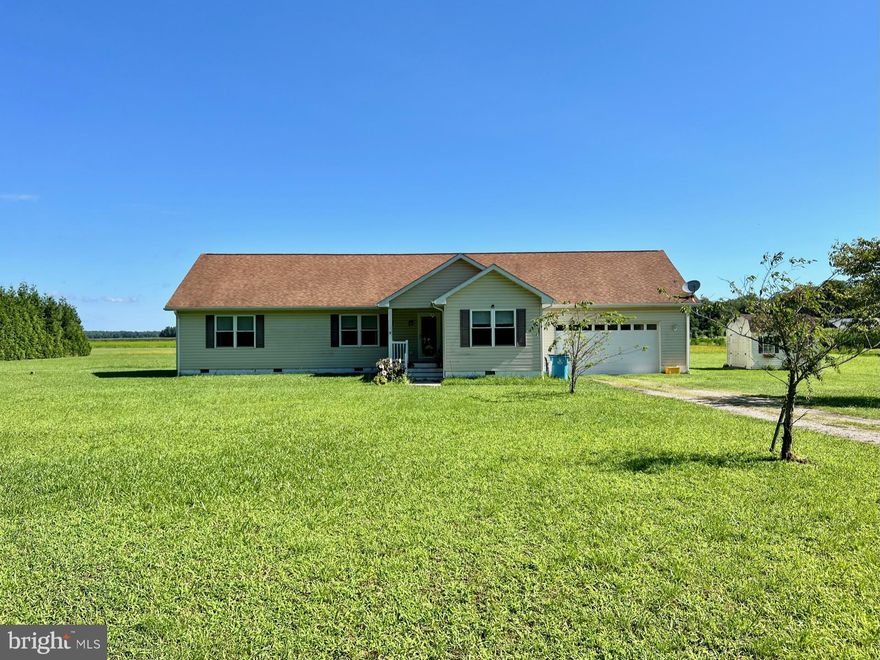 Quiet country setting on Shavox Church Raod, Whaleyville,  yet 15 minutes to Ocean City, Fenwick Island (depending on time of year!) and other points of interest on the Shore. This home was built a little over 10 years ago, and features 3 bedrooms, 2 bathrooms, utility room, sun room, and large attached garage (24 x 30) with an 8 x 16 overhead door and a rear entry door.  There is also a floored attic with plenty of storage space. Did I mention over 4 cleared acres? Quiet solitude, that could be the home for all kinds of animals. The floor plan is an open concept, with the living room, dining room, and kitchen all flowing together with laminate flooring and ceiling fans. The dining area opens to a sun room that is 12 x 15, with a minsplit unit for heating and cooling as well as tile floors for easy maintenance. The Main Bedroom is nicely sized, featauring an 8 x 8 walk in closet, it also has a huge bathroom 7 x 16, with a large fully tiled shower stall, and possible dressing area. There is also a rear deck and a covered front entry way.