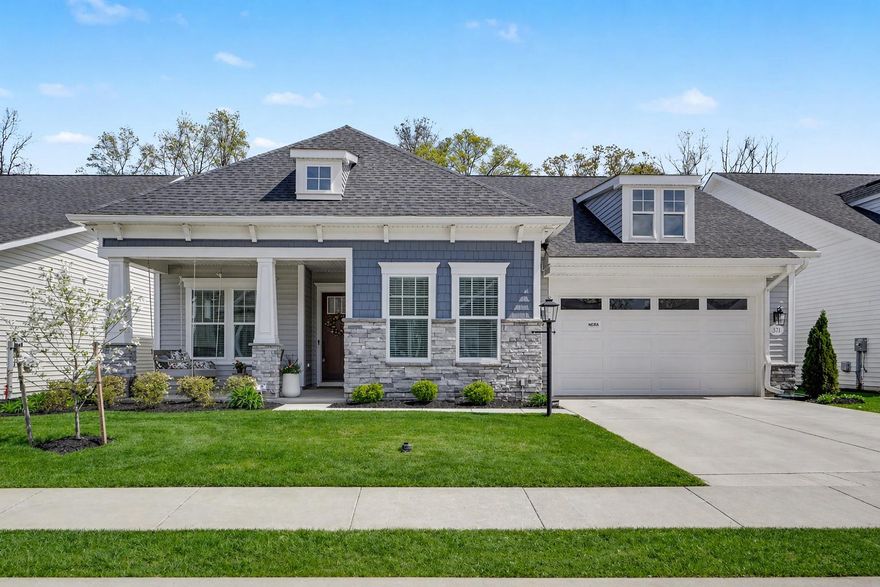 Welcome to The Quiet Creek House, a beautifully upgraded, move-in ready home in the heart of Amblebrook, a premier 55+ community designed for easy, resort-style living. Set on a premium lot backing to peaceful trees, this 2,400 square-foot home offers privacy, space, & thoughtful design throughout. From the charming front porch & timeless exterior with shaker siding, stone accents, & stately columns, to the soaring 10-foot ceilings inside, every detail feels warm & inviting.

Glass doors open to a private study that can easily serve as a third bedroom, while a guest bedroom & full bath are thoughtfully tucked away for comfort. The open-concept living area is anchored by a stunning kitchen with an oversized quartz island, KitchenAid gourmet appliances, & farmhouse sink. A butler’s pantry & spacious walk-in pantry provide exceptional storage, along with abundant cabinetry throughout. The subway tile backsplash extends all the way to the ceiling, adding a timeless designer touch. The kitchen flows seamlessly into a light-filled dining area, an open living room with a gas fireplace & custom built-ins, creating the perfect setting for both everyday living & entertaining.

The expanded primary suite is a true retreat. A custom trim accent wall adds character & warmth to the space. The ensuite bath features dual oversized vanities, a large tiled shower, & a private water closet. An impressive walk-in closet offers generous storage & connects directly to the laundry room, complete with built-ins, granite countertops, & a utility sink.

A heated four-season room extends your living space year-round. It features luxury vinyl plank flooring and stunning floor-to-ceiling windows that fill the space with natural light. Step outside to a fenced backyard featuring a beautifully hardscaped patio with a gas line ready for summer grilling. A full yard sprinkler system keeps the landscaping lush and low-maintenance.

 Additional highlights include an oversized two-car garage & a dedicated bulk storage room with built-in shelving for exceptional organization.

With indoor and outdoor resort-style pools, pickleball courts, a coffee shop, a state-of-the-art fitness center, and weekly social activities, life at Amblebrook truly feels like a vacation every day. Come experience the stunning details for yourself and schedule your private tour today.