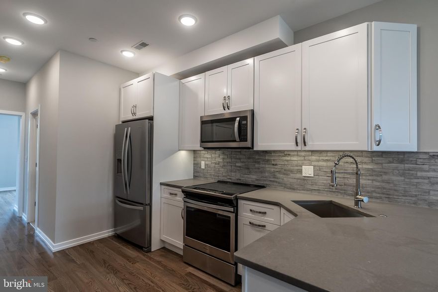 A gorgeous new construction unit in Grays Ferry, with parking! This beautiful unit includes desirable finishes and features throughout, including hardwood flooring, recessed lighting and large windows for ample natural light. The main floor includes an open, spacious living and dining area that naturally lead to a fabulous kitchen, complete with stainless steel Samsung appliances, quartz counters and stylish cabinetry. Continue through and discover the main floor bedroom with an ensuite bathroom for your comfort and convenience. Upstairs reveals two lovely bedrooms with ample closet space and ensuite bathrooms, along with laundry for your comfort and convenience. Found close to shopping, public transportation, major roadways and more, this is one you don't want to miss!