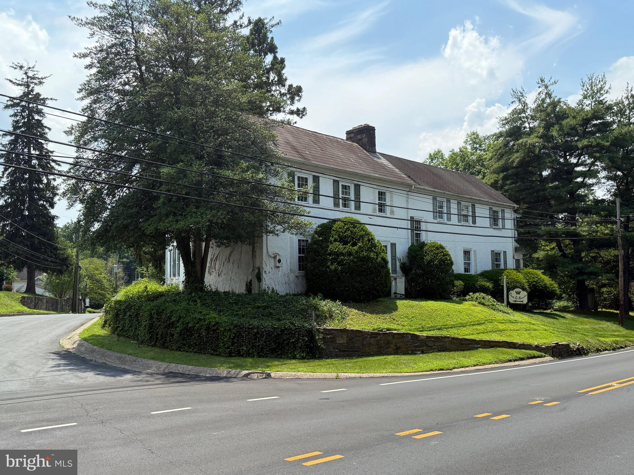 Incredible development opportunity in the heart of New Britain Borough. 10 Beulah Road offers a rare combination of location, zoning flexibility, and buildable land with strong frontage and visibility. The property spans 2.44 acres and features a freestanding commercial building measuring just over 7,500 square feet. Positioned on a corner lot with frontage on both Route 202 and Beulah Road, this site benefits from exceptional exposure and access, ideal for future residential or mixed-use development.
Zoned C-3 Office Commercial with a Mixed-Use Overlay, the property supports a wide range of potential uses, including residential, commercial, and mixed-use configurations. The building is currently occupied by month-to-month commercial tenants, allowing flexibility for redevelopment or holding income during the planning and entitlement process. Copies of leases, building sketches, and an estimate for public water hookup are available upon request.
The seller has conceptual site plans and sketches illustrating the maximum density of townhome units that may be achievable under current zoning — an ideal starting point for builders and developers looking to enter the highly desirable Doylestown-area market. With its location just minutes from downtown Doylestown, Delaware Valley University, and major commuter routes, this site is exceptionally well-positioned for long-term growth and development.