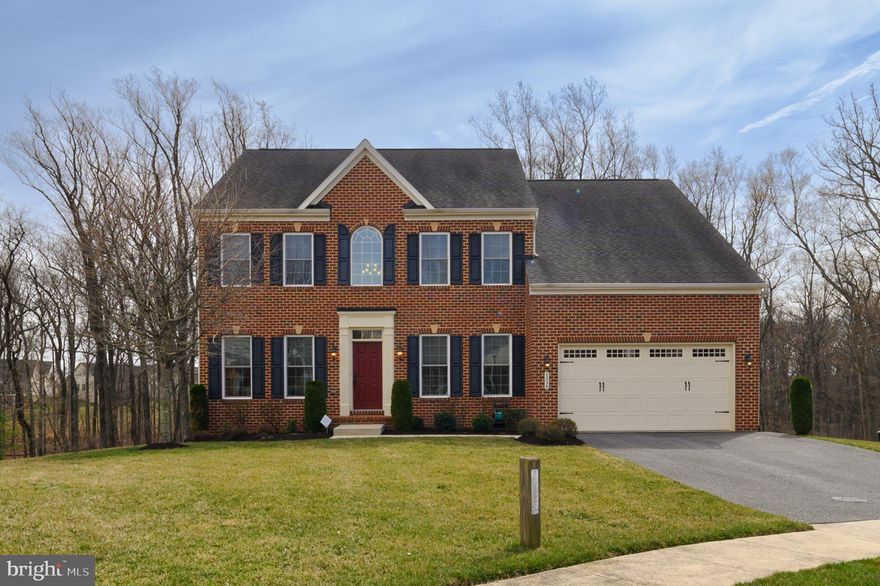 Great entertainment home for all seasons! This stunning NV Empress model is the perfect home for year-round entertaining, nestled in a prime cul-de-sac location with serene woodland and stream views. The elegant brick-front home features 4 bedrooms, 3.5 baths, and a two-car garage. Inside, a transitional floor plan welcomes you with a grand two-story foyer and an impressive staircase adorned with hardwood stairs and wrought iron spindles.

The main level offers a private office or music room, a formal living room, and beautiful hardwood flooring in the foyer, hallways, office, and powder room. The gourmet eat-in kitchen boasts an extended dining area, custom backsplash, maple cabinetry, upgraded gas cooktop with a five-burner heavy grate vented to the outside, granite countertops, and a granite-topped island with built-in cabinetry. High-end appliances include a GE Profile microwave combo convection oven, an additional GE Profile wall oven with both conventional and convection cooking, and a GE refrigerator with a water and ice dispenser. Ceramic tile flooring enhances both the kitchen and dining area. Adjacent to the kitchen, the inviting family room features a cozy gas fireplace. The formal dining room is elegantly appointed with a tray ceiling, crown molding, wainscoting, and chandelier lighting.

Upstairs, the luxurious owners' suite offers a tray ceiling, ceiling fan, two spacious walk-in closets, and dual corner windows with private woodland views. The spa-like en-suite bath includes two individual granite-topped vanities, a soaking tub, a separate shower, and a private water closet. The upper-level laundry room is conveniently equipped with a front-load washer and dryer, a laundry tub, shelving, and ceramic tile flooring.

The finished walk-out lower level provides ample storage space, a full bath with a tub/shower combo, and a builder-added 15-foot storage closet. The seller has also added custom built-in shelving and open storage in the mechanical area, with an additional door leading outside.

Outdoor living is a dream with a maintenance-free Fiberon (Trex-type) deck featuring acrylic railings, all overlooking a peaceful, panoramic woodland view—perfect for spring and summer cookouts.

Don’t miss this incredible home—call today for a private tour!