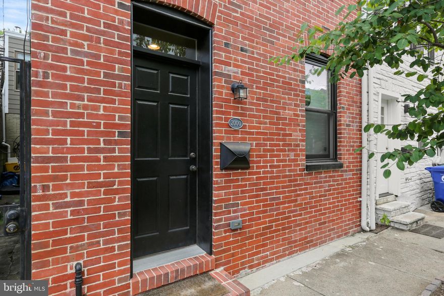 Located in Fells Point, this beautifully renovated three level home offers 1700 square feet of living, including 3 large bedrooms and 2 full baths.  Hardwood floors throughout.  The large eat in kitchen includes an island with seating, stainless appliances, granite counters, under-cabinet lighting.  Custom closets in bedrooms.   Large third floor primary suite includes a walk-in closet and beautiful bathroom with double vanity.  Two year new washer/dryer.  Roof sealed 2.5 years ago.  A 2-tier roof top deck includes water views.  Two years left on CHAP credit for savings of over $4200/year.  Parking available at nearby surface lot.  This lovely home is tucked away on a quiet street but also in the middle of great shopping and dining.  Schedule your showing today!
