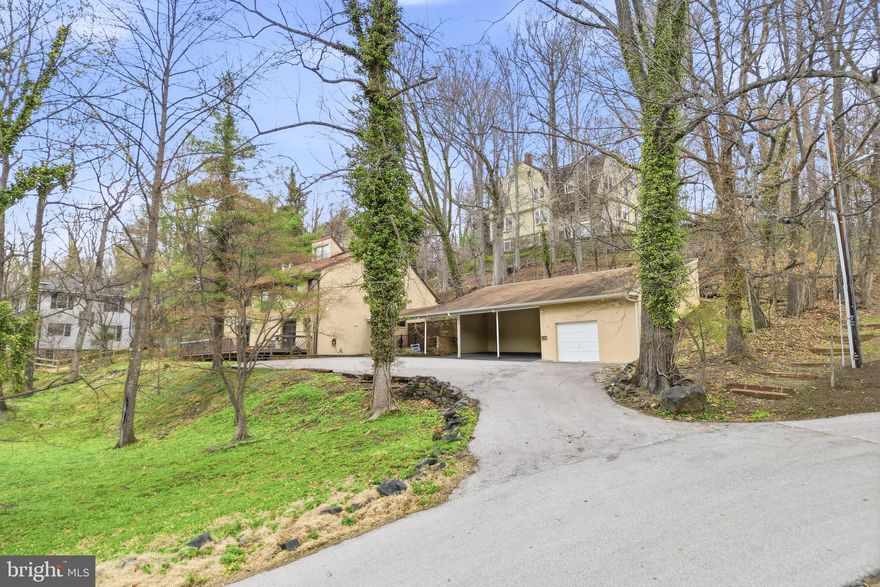 Don't miss this rare opportunity to own a beautifully unique and thoughtfully designed Contemporary/Mid Century Modern Style home in Mount Washington with unlimited possibility for everyday living! Tucked away on a private road in a 15-home community, custom-built, and sitting on .82 acres of wooded grounds there is really nothing else like it.  Approximately 4,875 square feet of living space with 5 bedrooms, 3.5 baths. This multi-level home is filled with character and endless potential for entertaining, featuring soaring cathedral ceilings, skylights, stone walls, slate flooring, built-ins, a wood-burning stove, a billiards room and other expansive entertaining spaces throughout. The kitchen is full of style and functionality while open to a large table space in the open main level that flows seamlessly from two points of entry to an expansive deck overlooking a green park-like setting perfect for outdoor gatherings. Upper levels include a spacious entertainment room with a stone bar, a private primary suite with cedar walk-in closet and dressing room or office, plus additional bedrooms, updated bathrooms and flexible living areas. Lower levels offer even more room for guests, recreation, storage, or customized use. Thoughtfully updated baths, appliances, roof, deck, HVAC, and more. 3 car carport and garage with expansive driveway makes parking multiple cars daily a breeze. Ideally located near top rated public and private schools, Mount Washington Village, Whole Foods, light rail, nature trails, parks, Sinai and Mount Washington Pediatric Hospital GBMC, and Johns Hopkins Hospitals, and easy access to I-83 and 695. This Amazing Value is A MUST SEE!