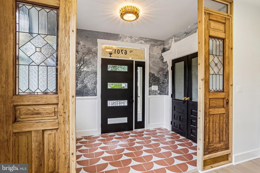 Don't miss this home! Prepare to be wowed! This brand-new, move-in-ready Mid-Century Craftsman custom home, offers 4500 sq ft of stunning design.  Featuring 6 bedrooms, 6.5 baths, and a 2-car attached garage. A garage is a dream in TP-no parking worries, and this oversized space is sleek inside and out.  This Takoma Dream boasts vintage doors, wood-clad walls, built-ins, and a secret room.  Just finished and sparkling new-ignore days on market. 
The first floor includes a vestibule with salvaged architectural doors, artistic wallpaper, a full bath and a private room that can be sectioned off as a suite. Stained glass pocket doors sourced from an upstate NY mansion frames this clever design. Just right for parents or an office.  A light-filled living room with a gas fireplace is perfect for coffee or cocktails.  An incredible two-toned kitchen is huge and is a wide-open space.  A clever Prep Kitchen is perfect for parties and hides it all. Of course, there is a restaurant-style range in the coolest color, and fabulous island. Look for the windows above the cabinets-custom, clever and brings that light in! A family room with high ceilings and custom wall cladding opens via glass sliders to a deck overlooking Spring Park. A stylish mud-room has a powder room, and a surprise, a doggy wash.
The first upper level has the desirable four bedrooms, including a primary suite with corner windows, skylights, a shower and a toilet with computer controls, and heated floors. Lux lives here! Two additional full baths are on this level and the colors are professionally designed. No white and grey here!  A unique Mondrian-influenced staircase leads to lofted spaces, including a fifth sky-lit bedroom with a full bath, high ceilings, built-ins, and flexible hang-out/office space. Think yoga room or office or another suite for work and family. Tree-top views make these spaces a sanctuary from stress.
The lower level offers a party kitchenette, a sixth bedroom with a full bath, a huge rec room, and an additional laundry connection. This front porch living is perfection! Protected trees provide shade and views from the front porch. Nothing compares, the colors, the designs, the absolute wow factor can be yours! Takoma Park is a walkable urban/suburban lifestyle, restaurants, Metro, shopping and schools to choose from. Take the dreamy virtual tour and then come in person. Priced just right and ready to move right in! A similar new home by Special Space Design & Restoration is under construction next door. A local award-winning local builder! History meets Modern here!