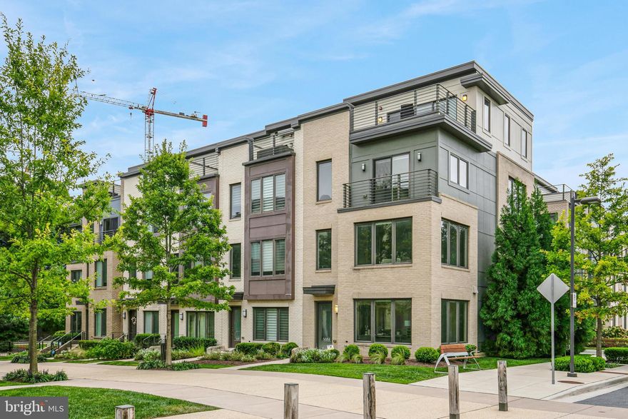 Stunning Corner-End Unit Townhome with Best View in Montgomery Row

This exquisite 5-bedroom, 4.5-bath corner-end unit is the newest and most premium home in the entire Montgomery Row community. Nestled in the best location, overlooking the serene Community Park, this 4-level townhome combines modern luxury with flexible living spaces. Built by EYA in 2018, and upgraded with over $150,000 in high-end finishes, this home exemplifies sophistication with custom details throughout.

Main Level Features:

Expansive Open Floor Plan: With 9’ ceilings and hardwood floors, the main level is ideal for entertaining. The striking white kitchen boasts quartz countertops, stainless steel appliances, 42" maple cabinets, and an impressive 11 ft. island, offering ample space for cooking and gathering.
Elegant Living & Dining Areas: A bright, spacious living and dining room features a gas fireplace and a gleaming chandelier, creating a warm and inviting atmosphere.
Upper-Level Retreats:

Sophisticated Primary Suite: The primary bedroom includes custom-organized walk-in closets and a separate linen closet. The ensuite bath is a haven of elegance, featuring dual sinks, a frameless glass shower with marble bench seating, and abundant natural light.
Spacious Bedrooms: Two additional bedrooms are bright and roomy, each with ample walk-in closets. An additional full bath is located on this level.
Convenient Laundry: A full-size washer and dryer on this level offer maximum convenience.
Top-Level Urban Oasis:

Private Rooftop Terrace: Enjoy a 669 sq. ft. rooftop terrace, perfect for lounging and dining, ideal for year-round relaxation and entertaining.
Loft/Flex Space: This level features a loft/family room (optional 5th bedroom) with a wall of windows, a full bathroom, and an additional closet—perfect for a home office or extra living space.
Entry-Level Suite & Garage:

In-Law Suite/Office: The versatile entry-level suite can function as a bedroom, office, or gym. It includes a living area, full ensuite bath, wet bar, and heated marble floors, adding a luxurious touch.
2-Car Garage: The large garage offers plenty of storage with built-in shelving and an organization system. Currently serving as an in-home gym, the space can be easily reconfigured to meet your needs.
Additional Features:

Custom window treatments, blinds, and upgraded light fixtures throughout
Quiet, premium location within the community
Low HOA fees
Parking: This home offers a 2-car garage, two visitor parking passes, and two owner parking badges for a gated security community garage—free for the homeowner.

Prime Location: Conveniently located near I-270 and I-495, Montgomery Row offers quick access to shopping at Montgomery Mall, Wildwood, Balducci’s, and Giant. Downtown Bethesda is just minutes away, with its top-tier restaurants, nightlife, and entertainment. Enjoy outdoor activities at nearby Cabin John Park, which features dog parks, ice skating, tennis, and trails. Public transportation, including the Grosvenor Metro, ensures easy commuting.

This home truly has it all—style, luxury, space, and location!