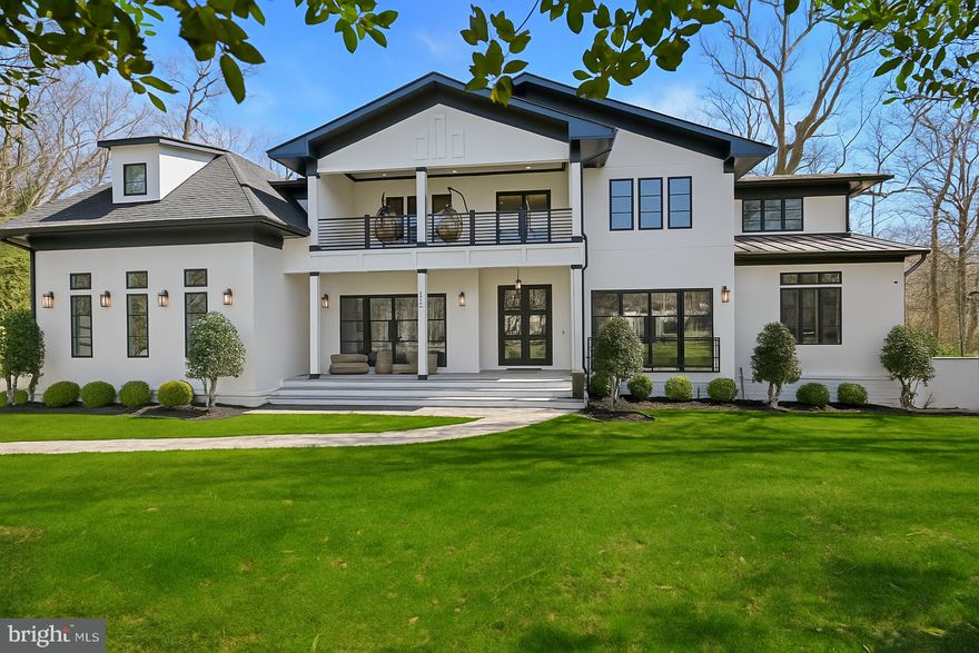 Tucked within the highly sought-after Langley Forest neighborhood, this stunning custom brick and stucco estate sits on 1.47 professionally landscaped acres. A private, park-like oasis complete with a picturesque stream that offers serene, scenic views all year round. Enhancing the retreat-like atmosphere is an infinity saltwater pool with elegant fountains, perfect for both relaxation and entertaining. Spanning over 11,000 square feet, this luxurious residence offers modern amenities, a four-car garage with soaring 15-foot ceilings (ready for car lifts), and an elevator serving all levels. Inside, the gracious foyer opens to formal living and dining rooms, while the inviting family room with fireplace seamlessly connects to an expansive deck overlooking the grounds. The chef’s kitchen is adorned with top-of-the-line appliances, including a built-in espresso machine and beverage chiller, plus the bonus of a full prep kitchen for effortless entertaining. Also on the main level is a private office, screened porch, and a mudroom with custom built-ins. Upstairs, the owner’s suite is a true sanctuary, complete with a cozy sitting room and fireplace, private balcony, dual walk-in closets, and a dream worthy bath featuring heated floors and a steam shower. Four additional en suite bedrooms and a convenient laundry room complete the second floor. The walkout lower level is designed for recreation and relaxation, offering a wet bar, fitness room, media room, bedroom, full bath, half bath, and a roughed-in space for a potential second laundry or kitchenette. Step outside to the covered porch and take in the pool, firepit, and golf putting green, all set against the tranquil backdrop of the gently flowing stream. Property includes a generator. Perfectly located inside the Beltway, this exceptional home offers easy access to top-rated schools, world-class shopping and dining, and major routes including the George Washington Parkway, Dulles Toll Road, and I-495. (**Images of optional sauna and laundry room are artistic renderings for illustrative purposes only. Features depicted are optional, available at an additional cost, and may differ in style or finish from the final product.)