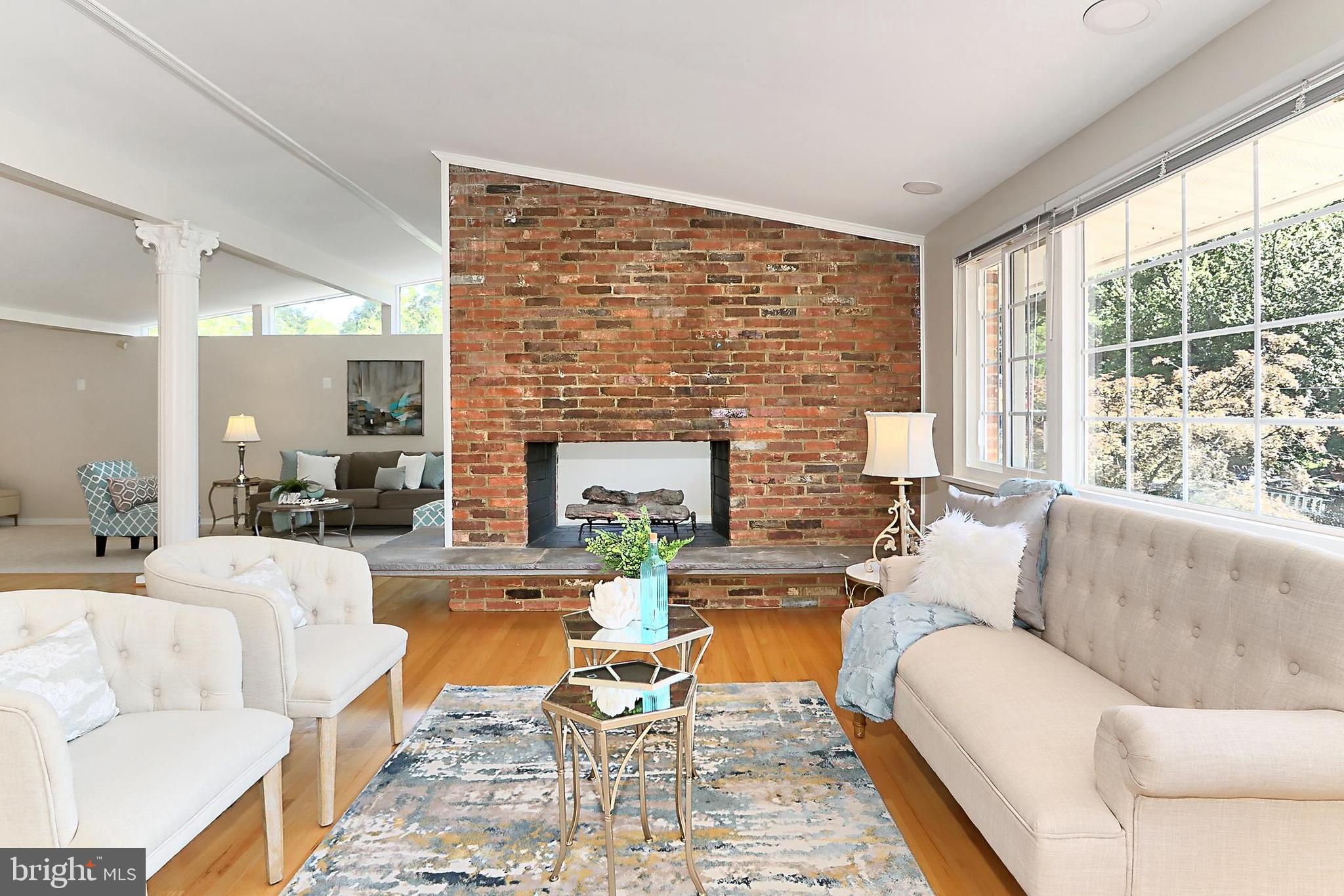 This Expanded home - in excellent condition with NEW Roof on entire home! Bright and OPEN floorplan with multiple extensions. This is more of a Great Room concept with so much flexibility. HUGE windows, Brick Wall see through Gas Fireplace is a focal point. Pretty hardwood floor on main level. Any carpeting is NEW. 3 room Owner's suite has a renovated bath, Sauna, access to the rear double deck and wonderful views. Home is freshly painted and ready for quick move-in. 3 bedrooms and 2 baths on the main level. Lower level is open - HUGE Family room with 2nd Masonry Fireplace with Gas logs. Bedrooms 4 & 5 are bright with NEW carpeting & hall bath & nearby Den for studying! Almost .4 acre fenced lot is very usable w/mature trees, 2 level deck, gazebo. 2 deep garages!!