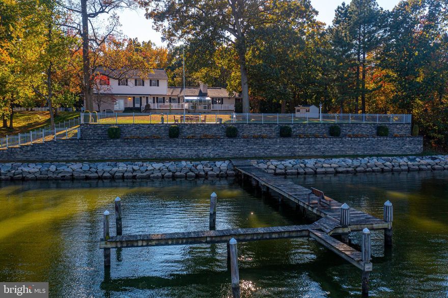 AGENTS - PLEASE VIEW AGENT REMARKS IN BRIGHT MLS.

WATERFRONT property situated on nearly 2.38 acres in the Middleborough community of Essex on Hopkins Creek. The residence boasts over 5,000 square feet, featuring 7 bedrooms and 4.5 bathrooms. The main level includes a living room/dining room combination with French doors opening to a solarium, a tray ceiling, a wood-burning brick fireplace, water views, hardwood floors, and a powder room. The kitchen is equipped with stainless steel appliances, including a French door refrigerator, disposal, dishwasher, built-in microwave, range, and trash compactor. The primary bedroom offers an attached bath and walk-in closet, complemented by two additional bedrooms and a full bath. A spiral staircase descends to a fully finished lower level, which encompasses a spacious media room with built-ins, a brick wood-burning fireplace, a wet bar with a sink and mini-fridge, a full bathroom, an office, storage, and a separate laundry room. The upper-level addition provides 4 bedrooms and a full bath. The property includes an attached 4-car garage, a detached 4-car garage, and a detached RV carport. Exterior amenities feature a circular driveway on a no-thru street, partial fencing, a large rear yard with two decks, a paver patio, exterior lighting, two sheds, a substantial retaining wall, a stone bulkhead, a private pier with 6 boat slips, and a sandy beach.

Please schedule all showings online via Showing Time.

Offers may be entered ONLINE through Thursday, November 13, 2025 at 5:00 pm.

AT SELLER'S DISCRETION, AN OFFER MAY BE ACCEPTED AT ANY TIME.