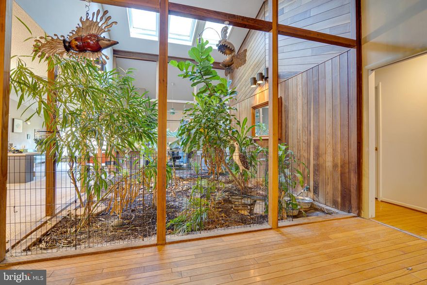 Gorgeous Contemporary home on 1.9 acres. This home is truly unique. Once you enter the large foyer with slate flooring, this  open concept is centered by the beautiful atrium , vaulted ceiling and skylights .  Large living areas separated by pockets doors to the bedrooms. Primary bedroom with sliding glass door entrance to the back deck, vanity outside bathroom, walk in closet, heat lamp and casement windows. Partially finished walk out basement with multiple entrances to the fenced back yard and patio. Potential to finish off the basement. Rough in bathroom with toilet installed. Brick breezeway between the detached side load garage and the kitchen entrance of the home.  Minutes to shopping and I-81 for commuters.